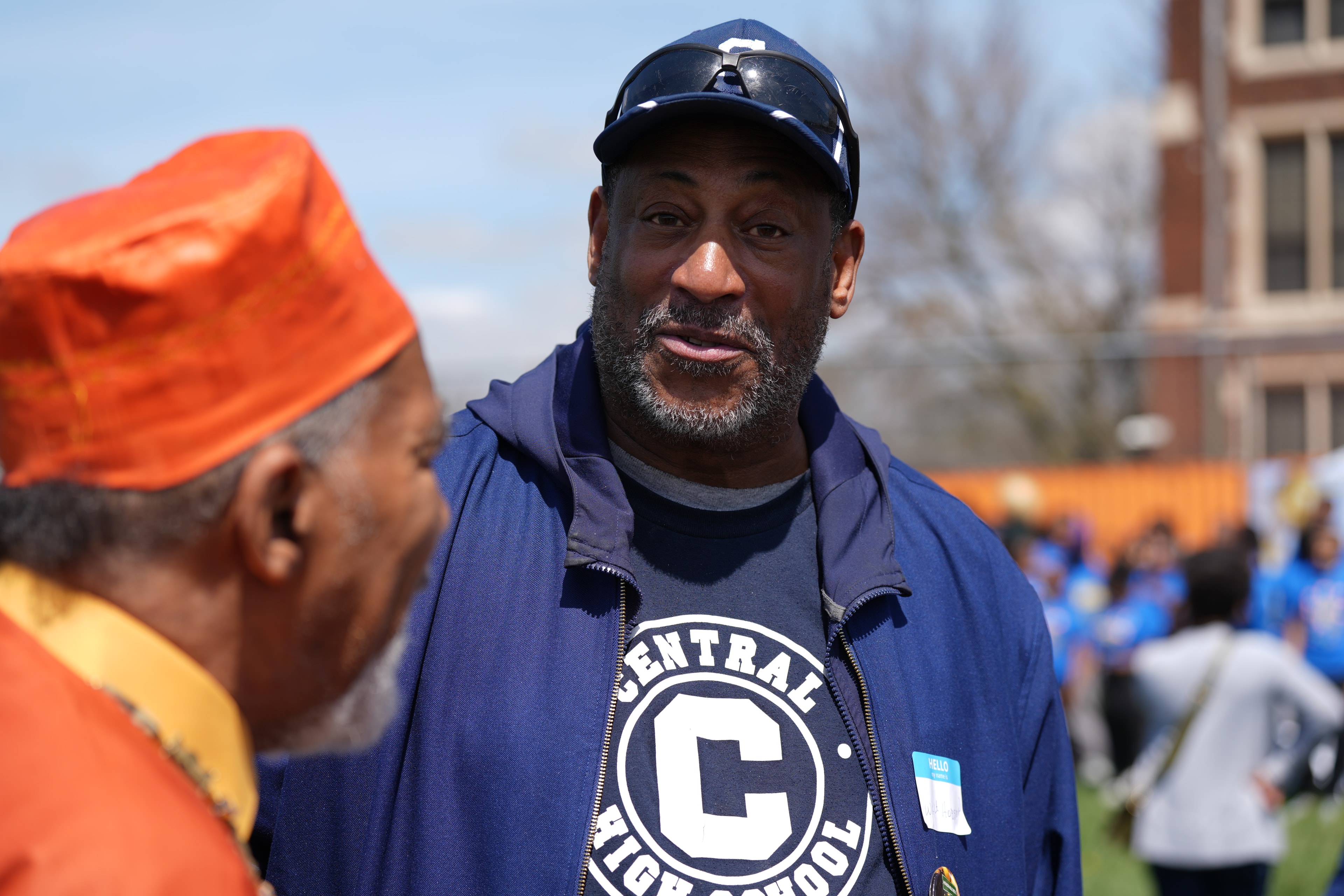 Man wearing baseball cap at outdoor event