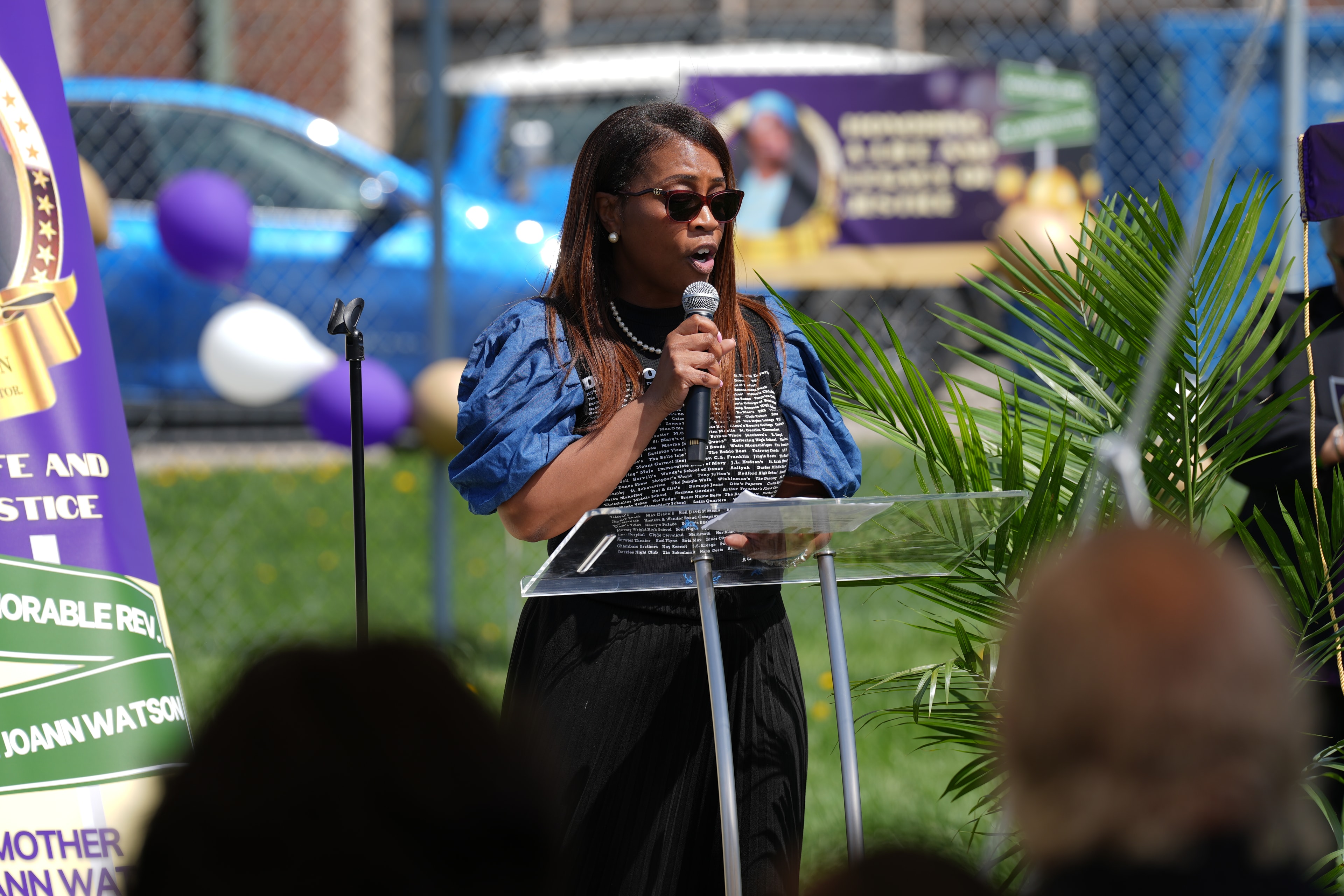 Woman speaking at outdoor community event