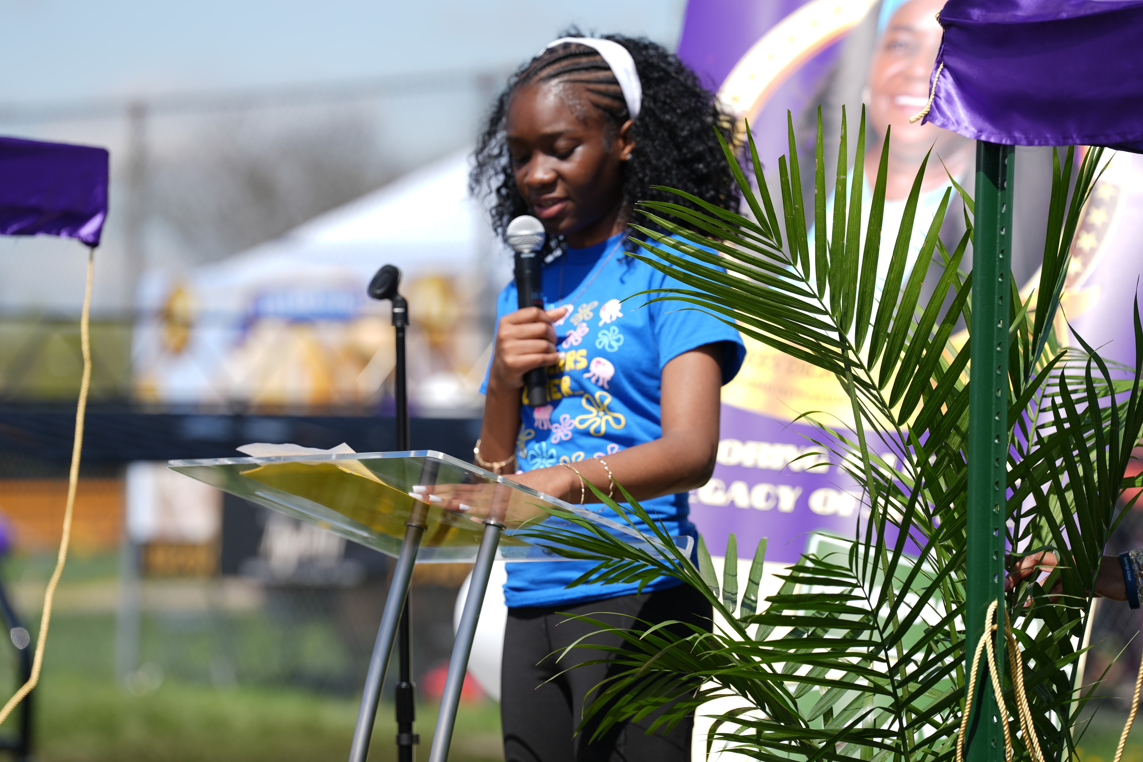 Woman speaking at outdoor event podium