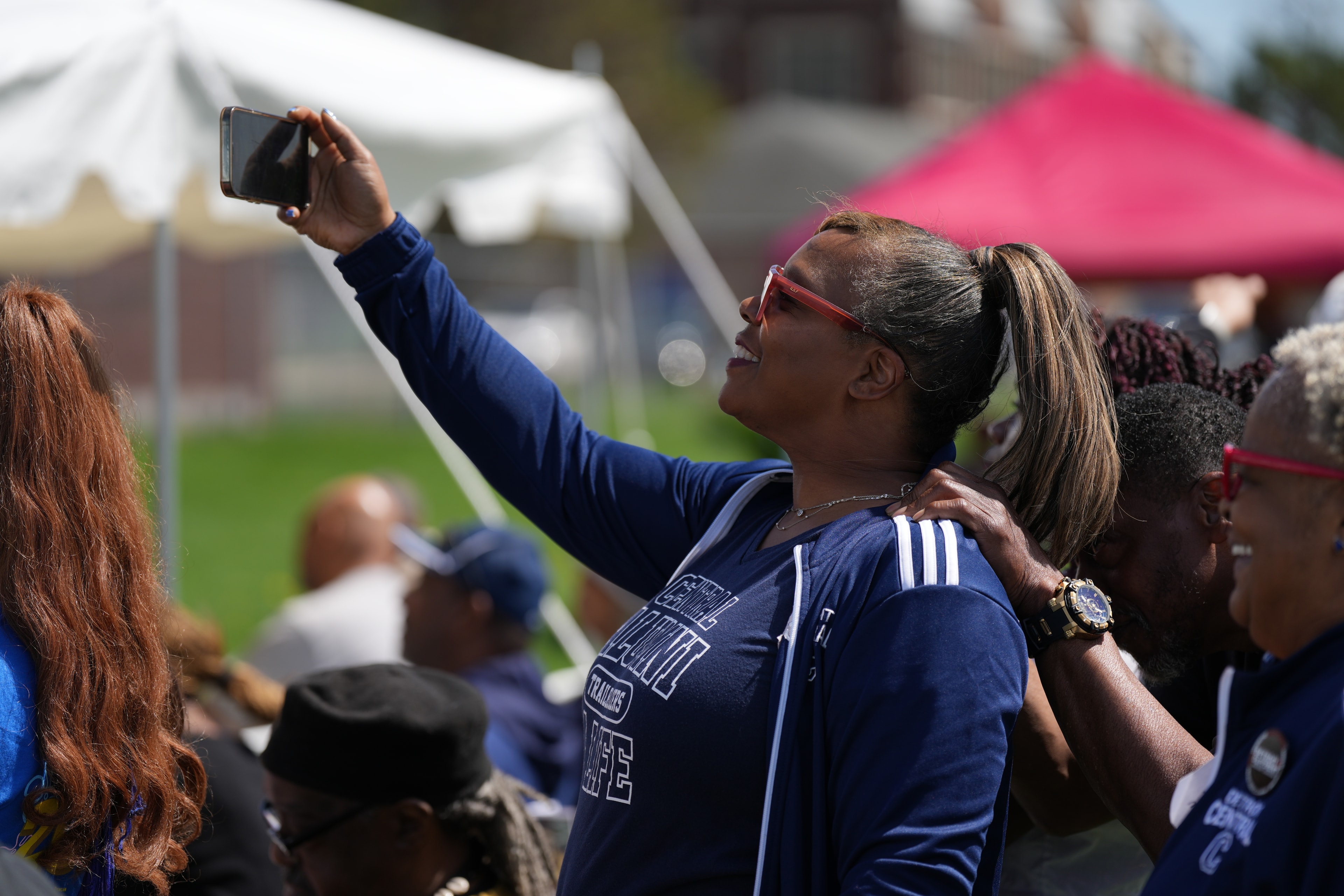 Woman taking selfie at outdoor event