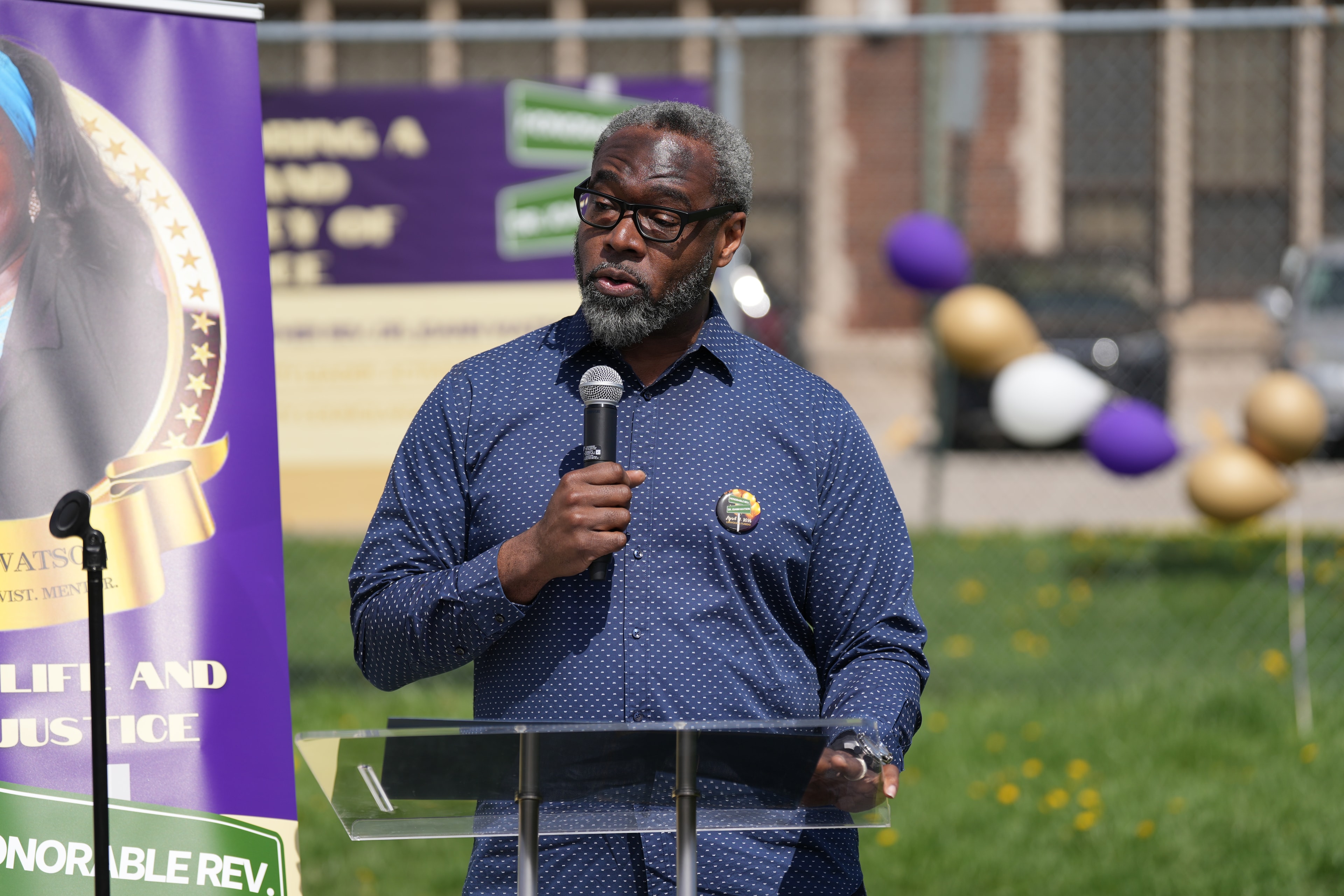 Man speaking at outdoor event podium