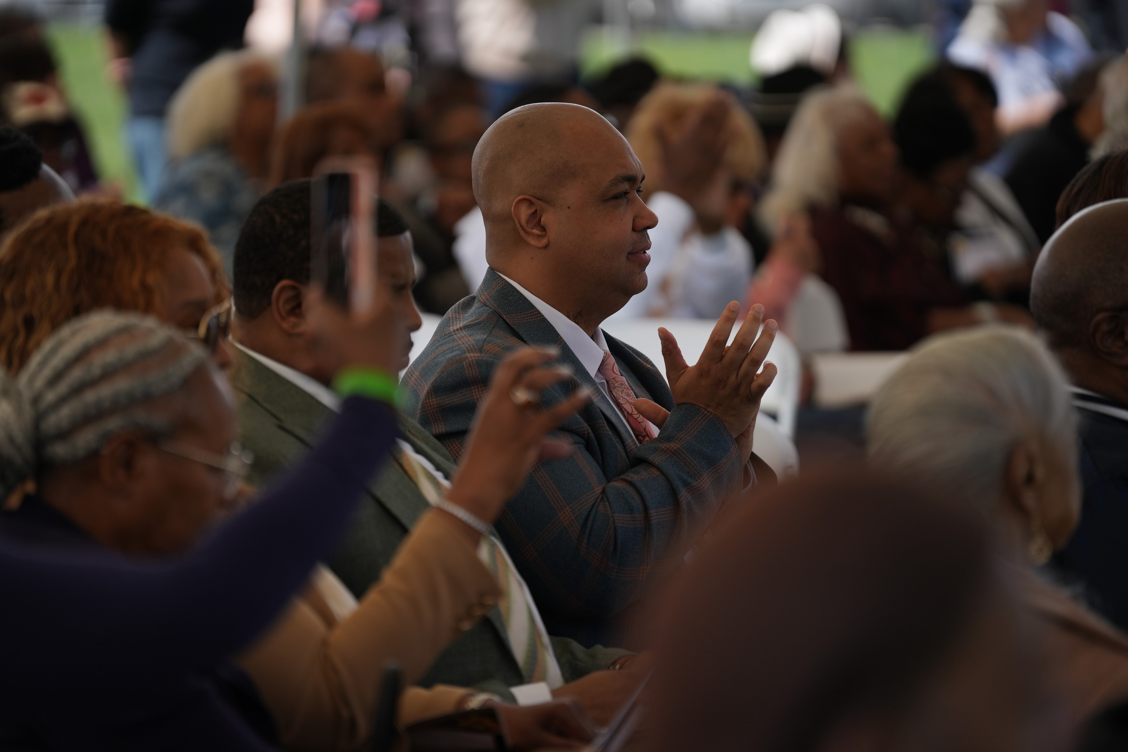 Man speaking to crowd at outdoor event