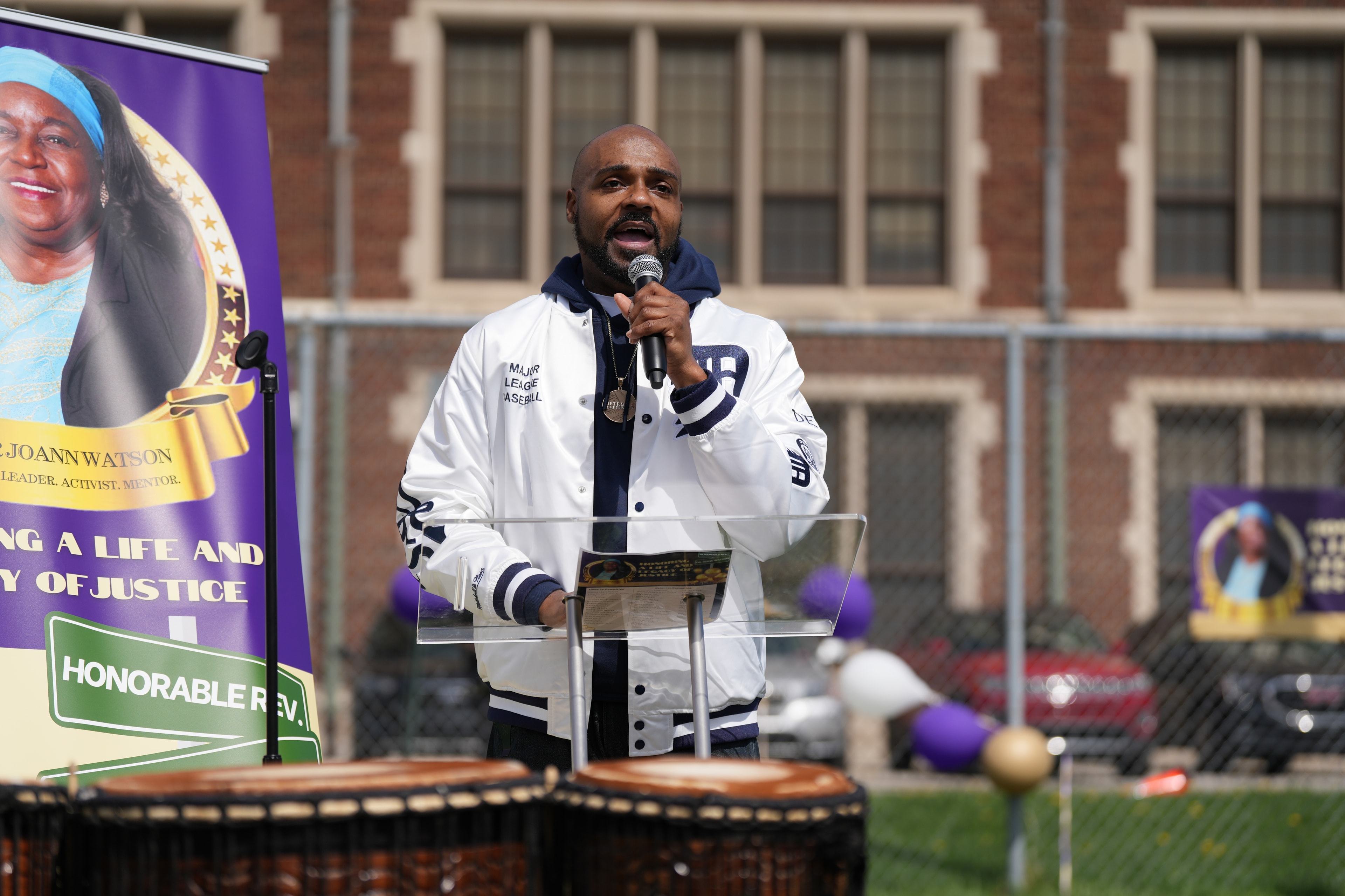 Man speaking at podium outdoor event