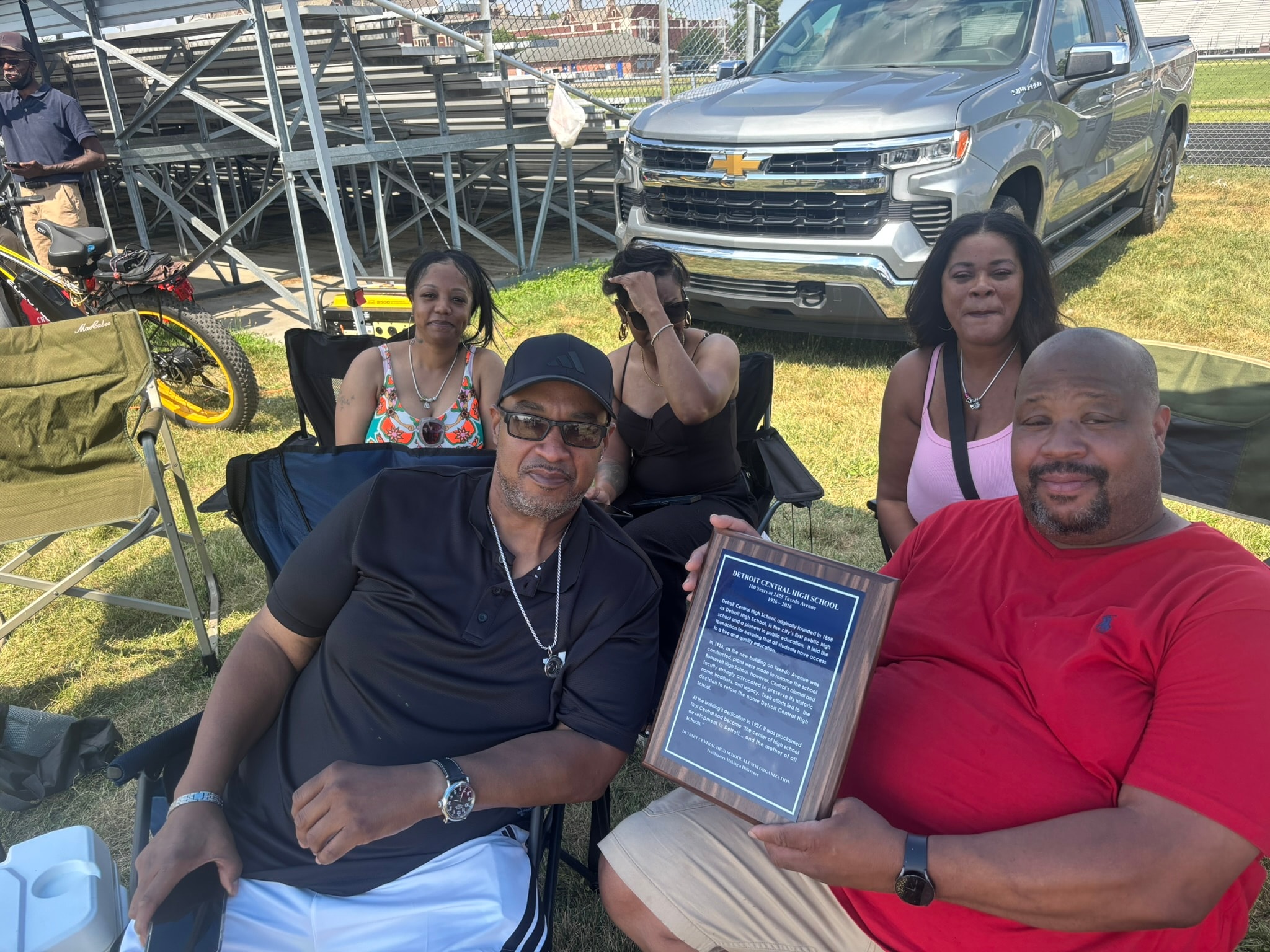 Group holding award at outdoor event