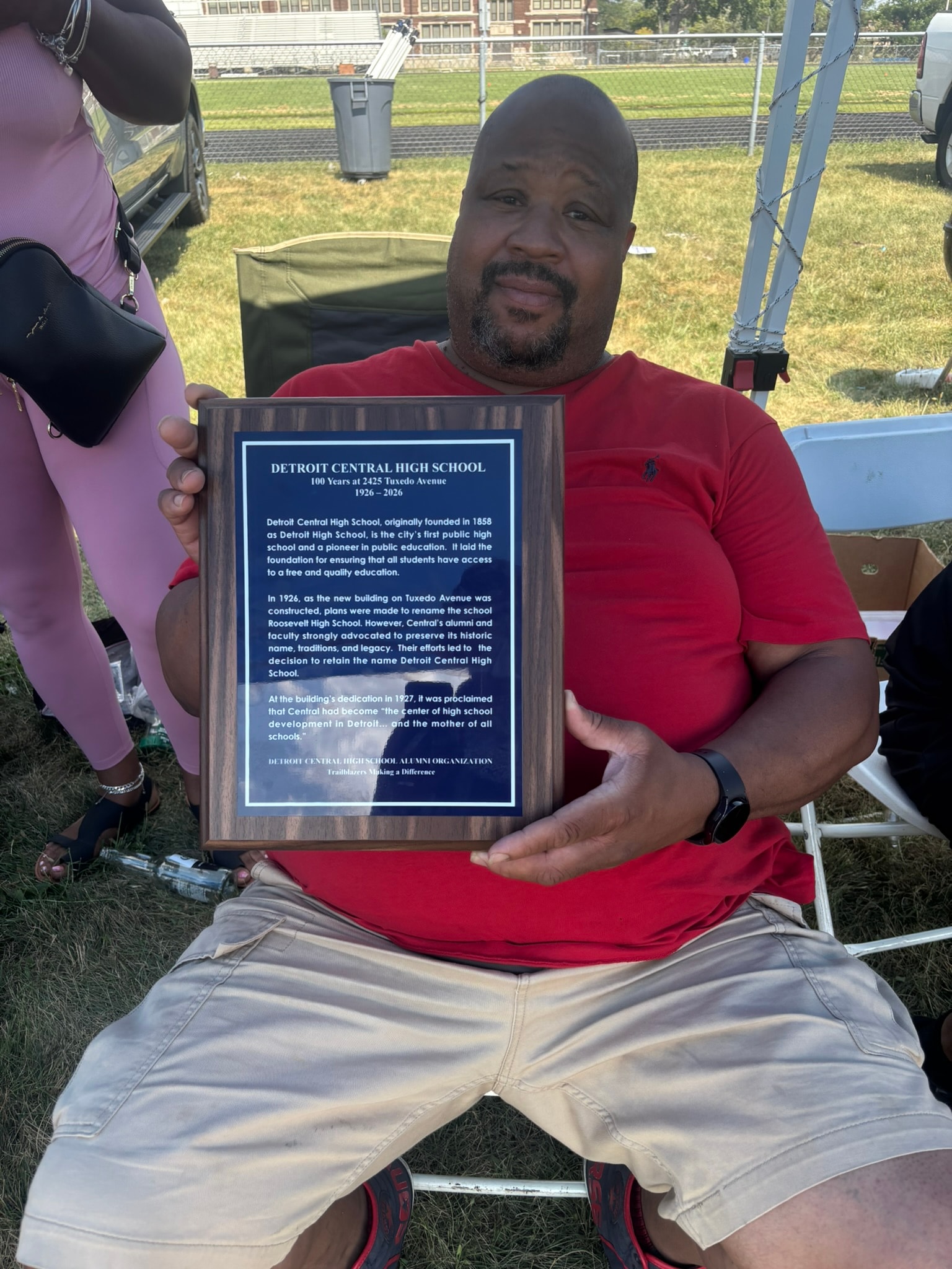 Man holding Detroit Central High School plaque