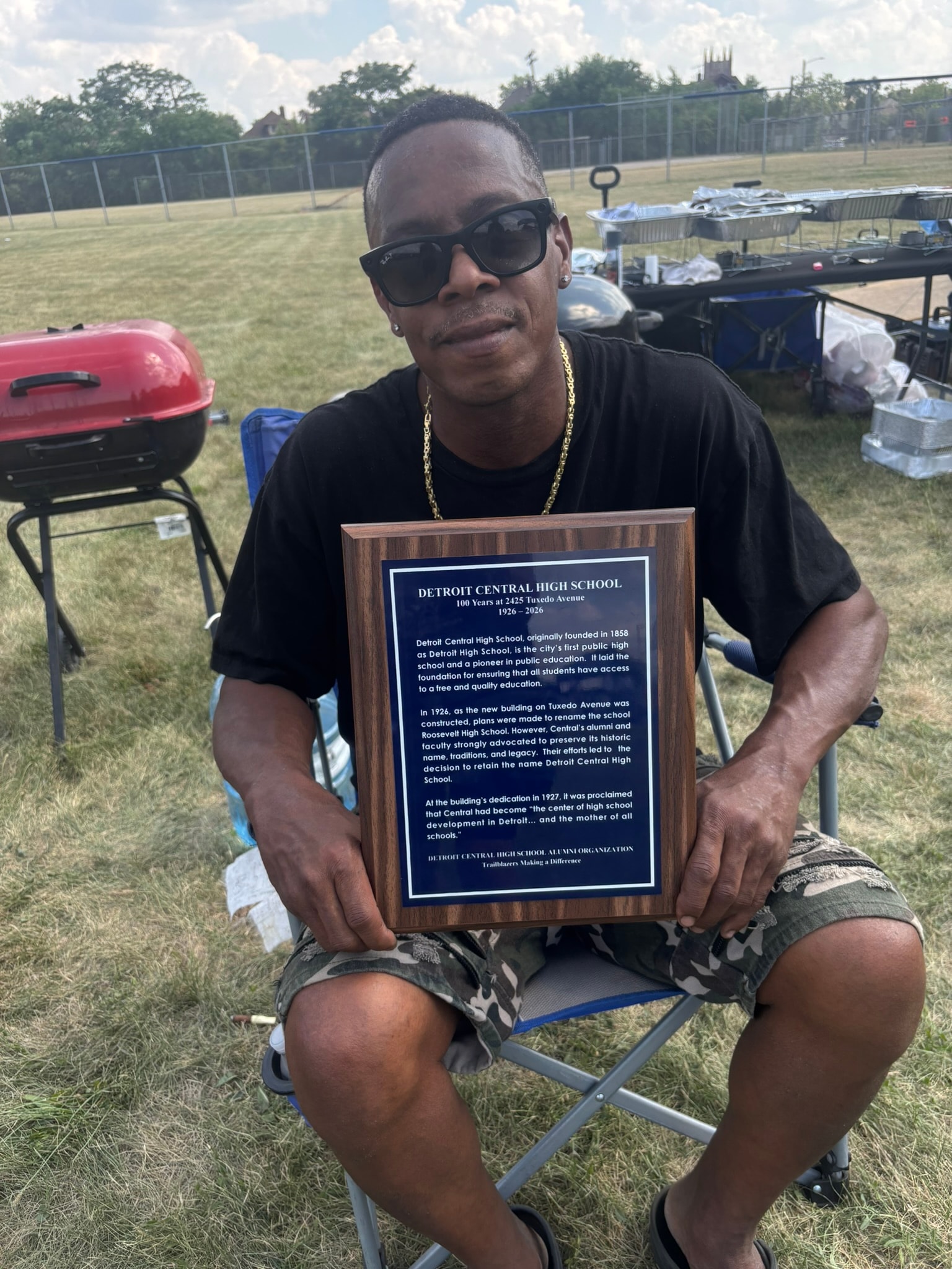 Man holding Detroit Central High School plaque