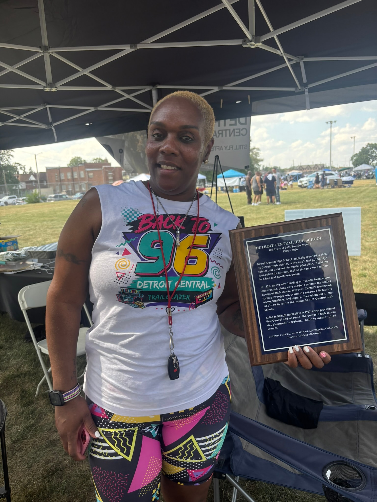 Woman holding Detroit Central High School plaque
