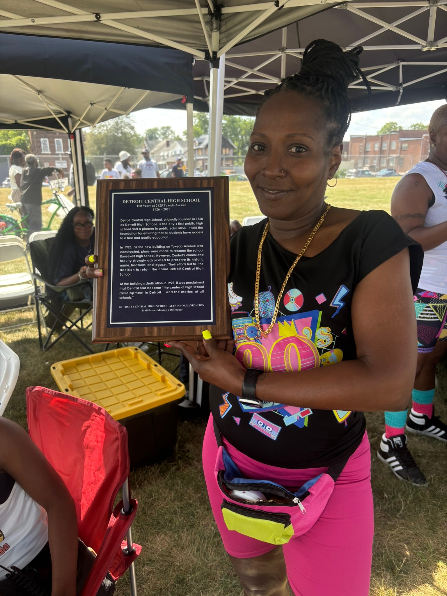 Woman holding Detroit Central High School plaque