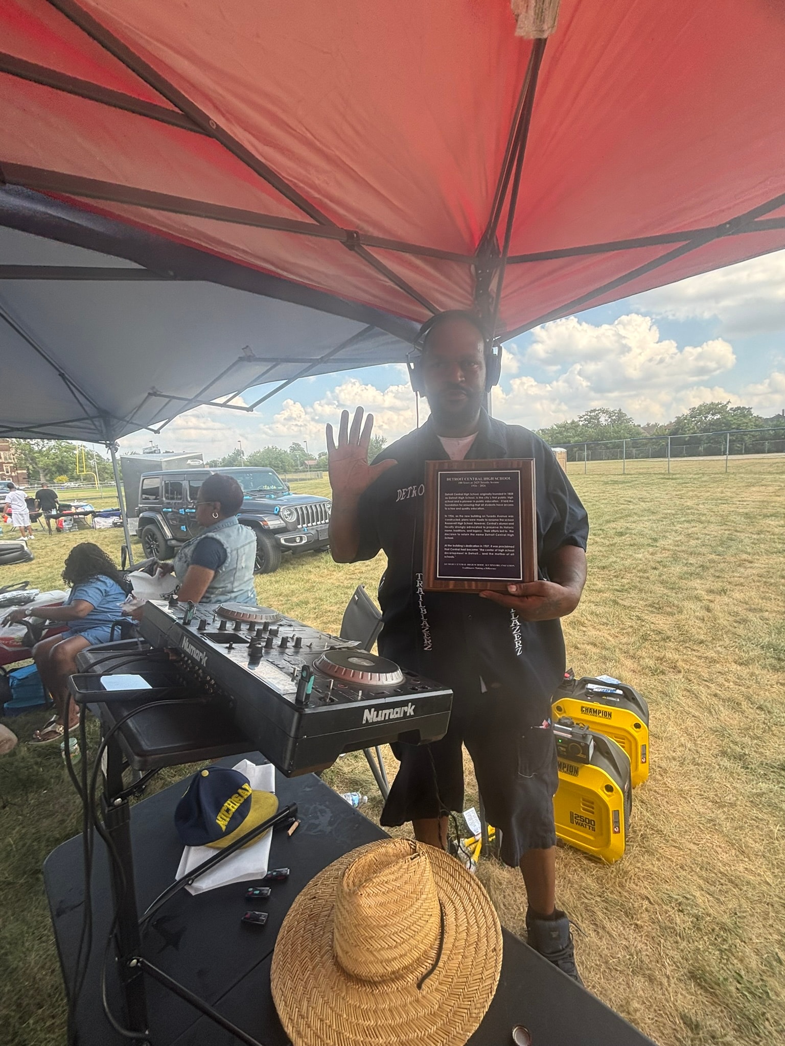 DJ holding award at outdoor event