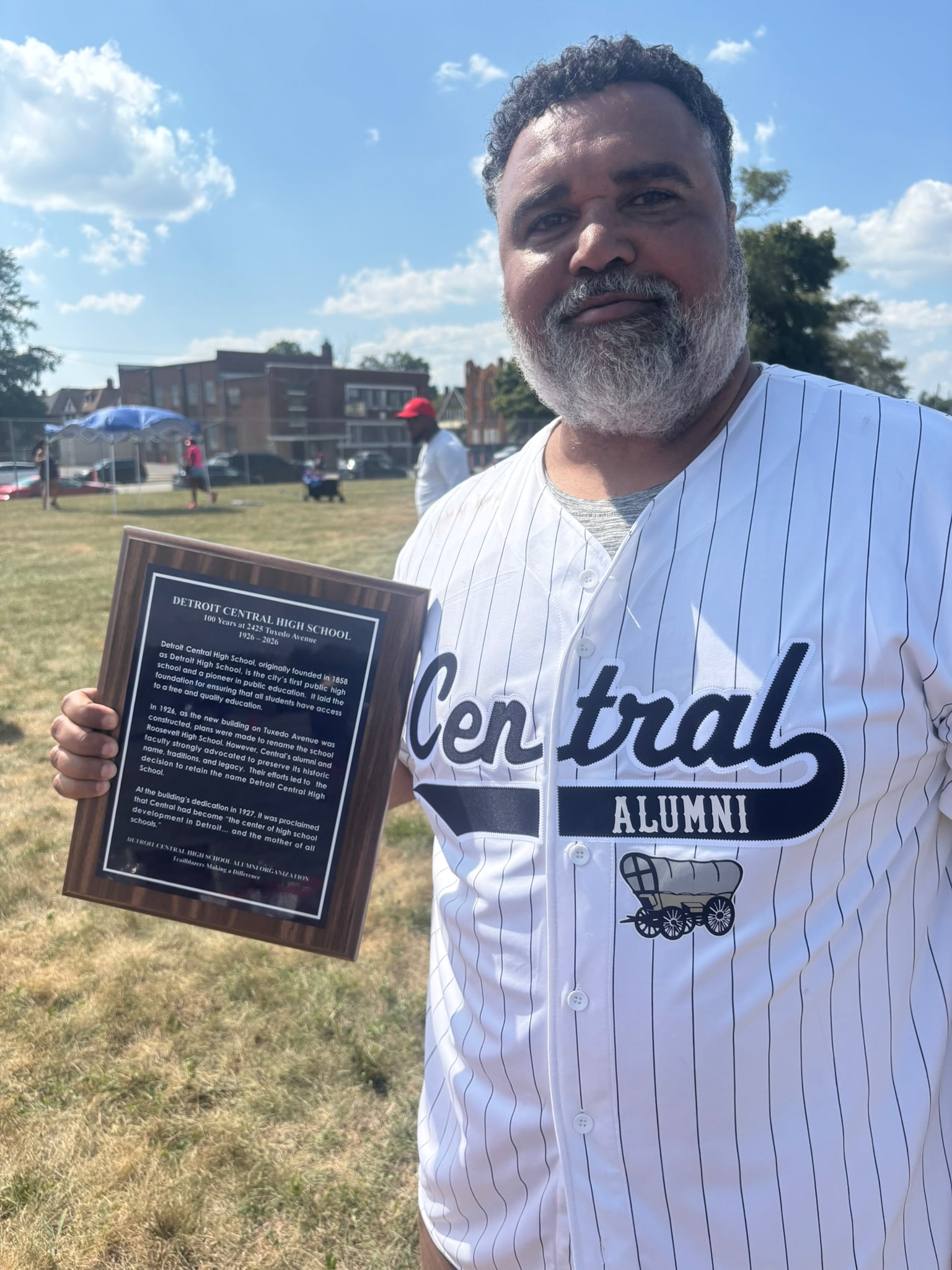 Man holding Detroit Central High School alumni plaque
