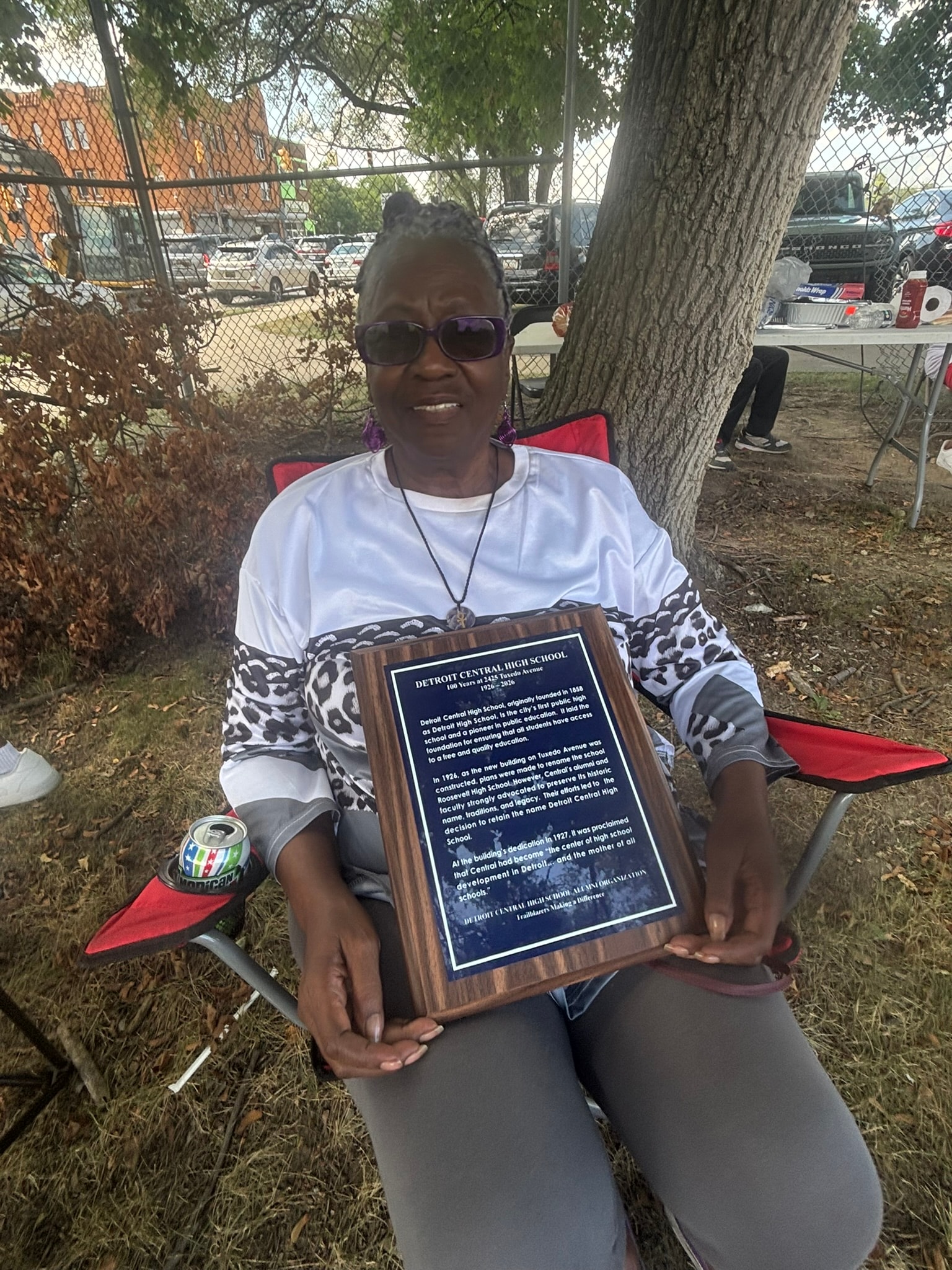 Woman holding Detroit Central High School plaque