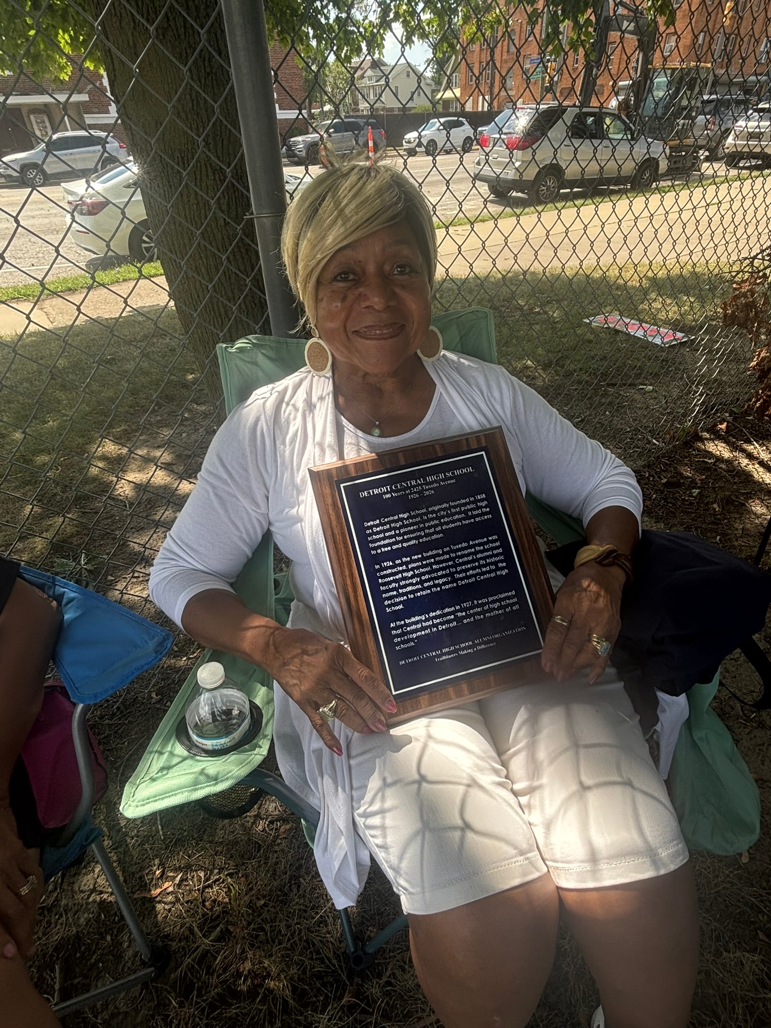 Woman holding Detroit Central High School plaque