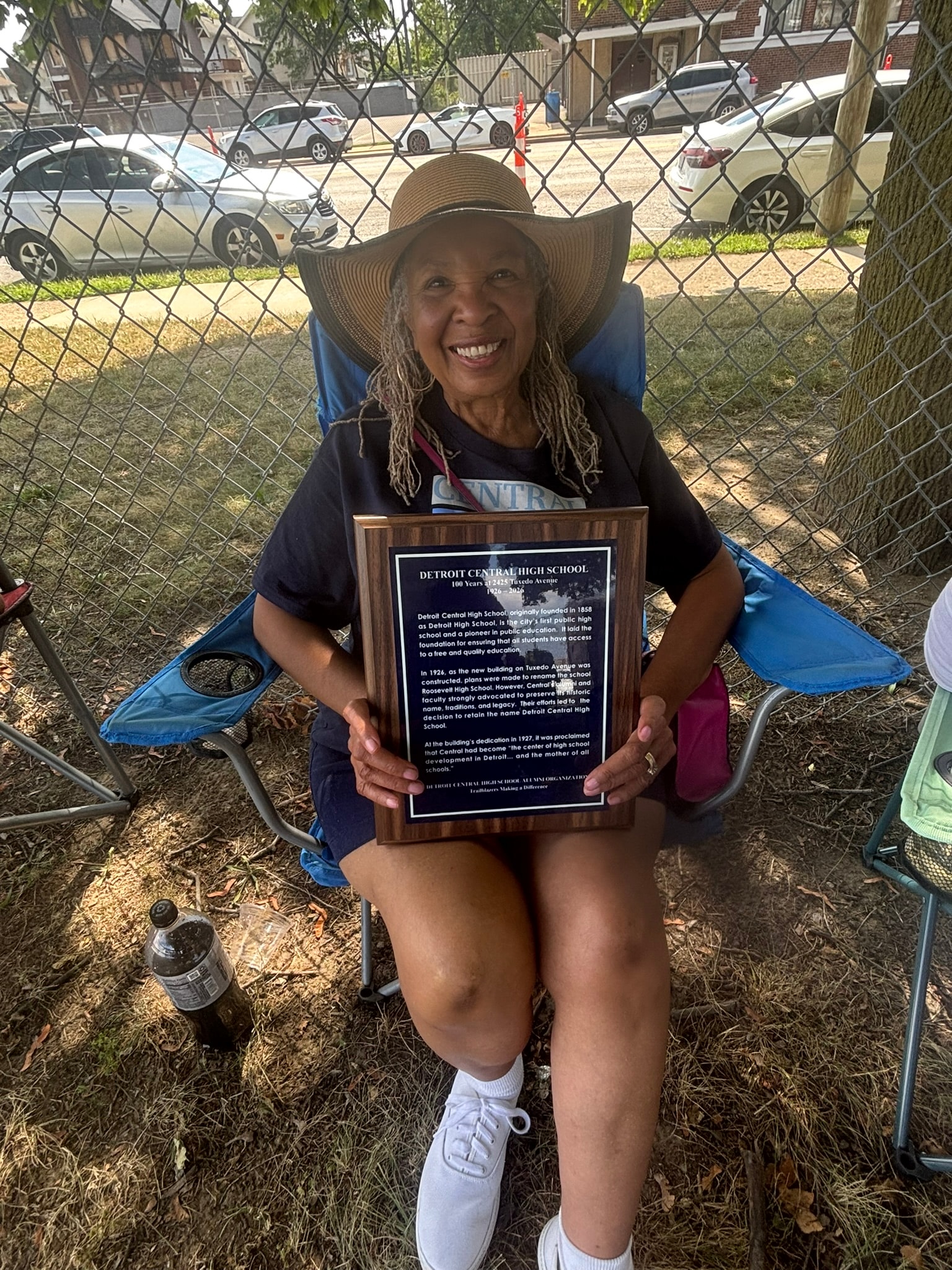 Woman holding Detroit Central High School plaque