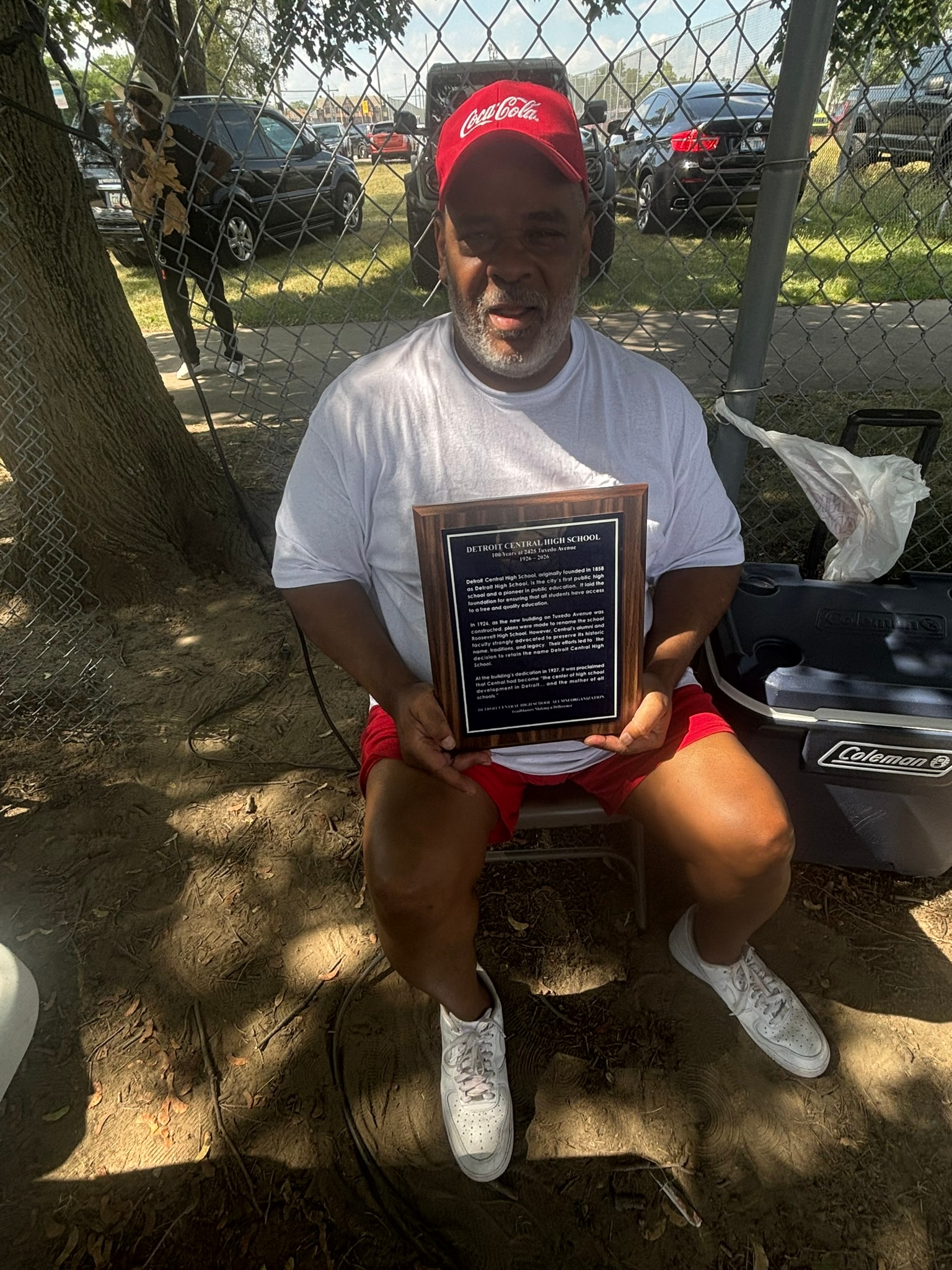 Man holding Detroit Central High School plaque