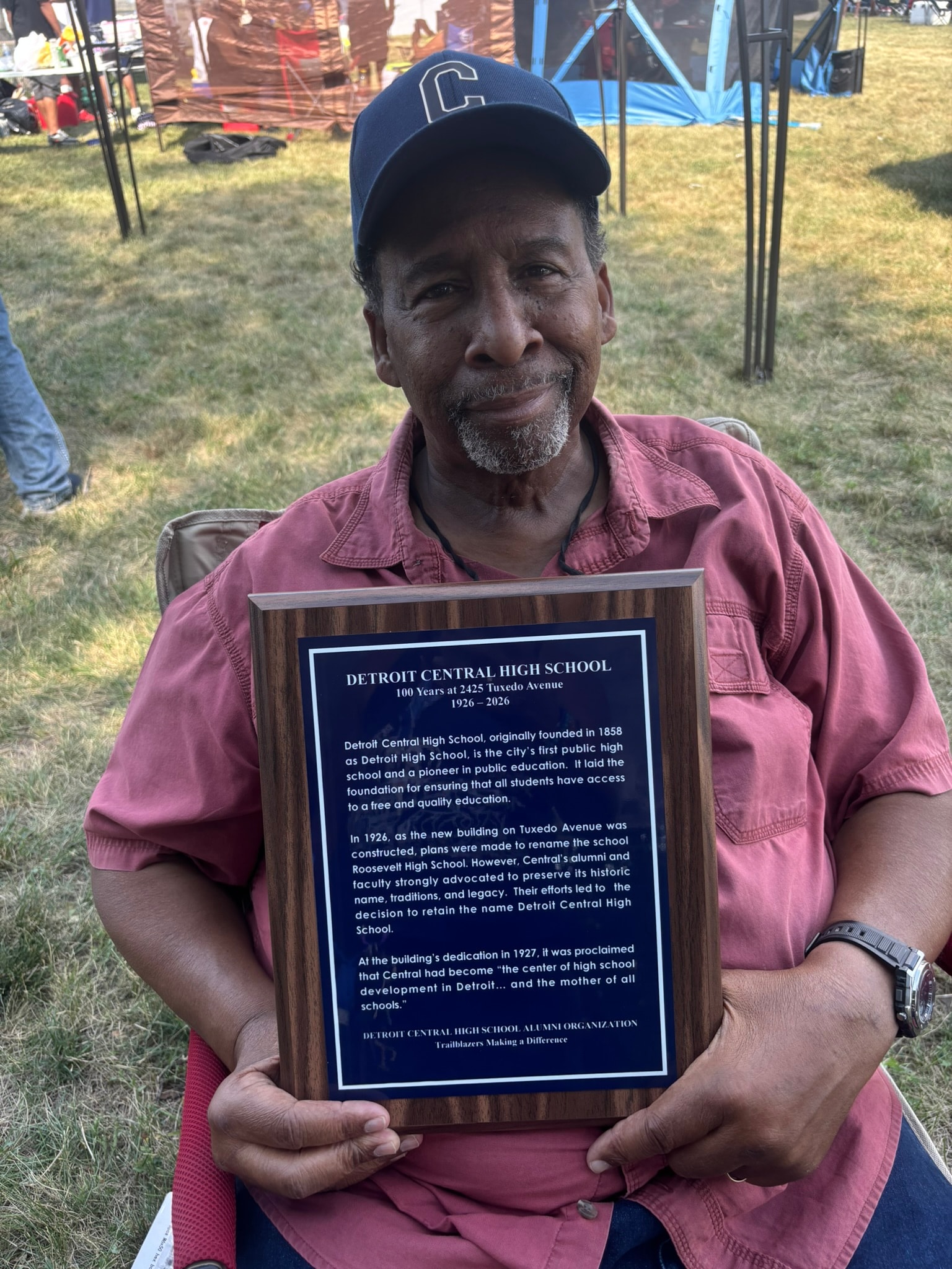 Man holding Detroit Central High School plaque