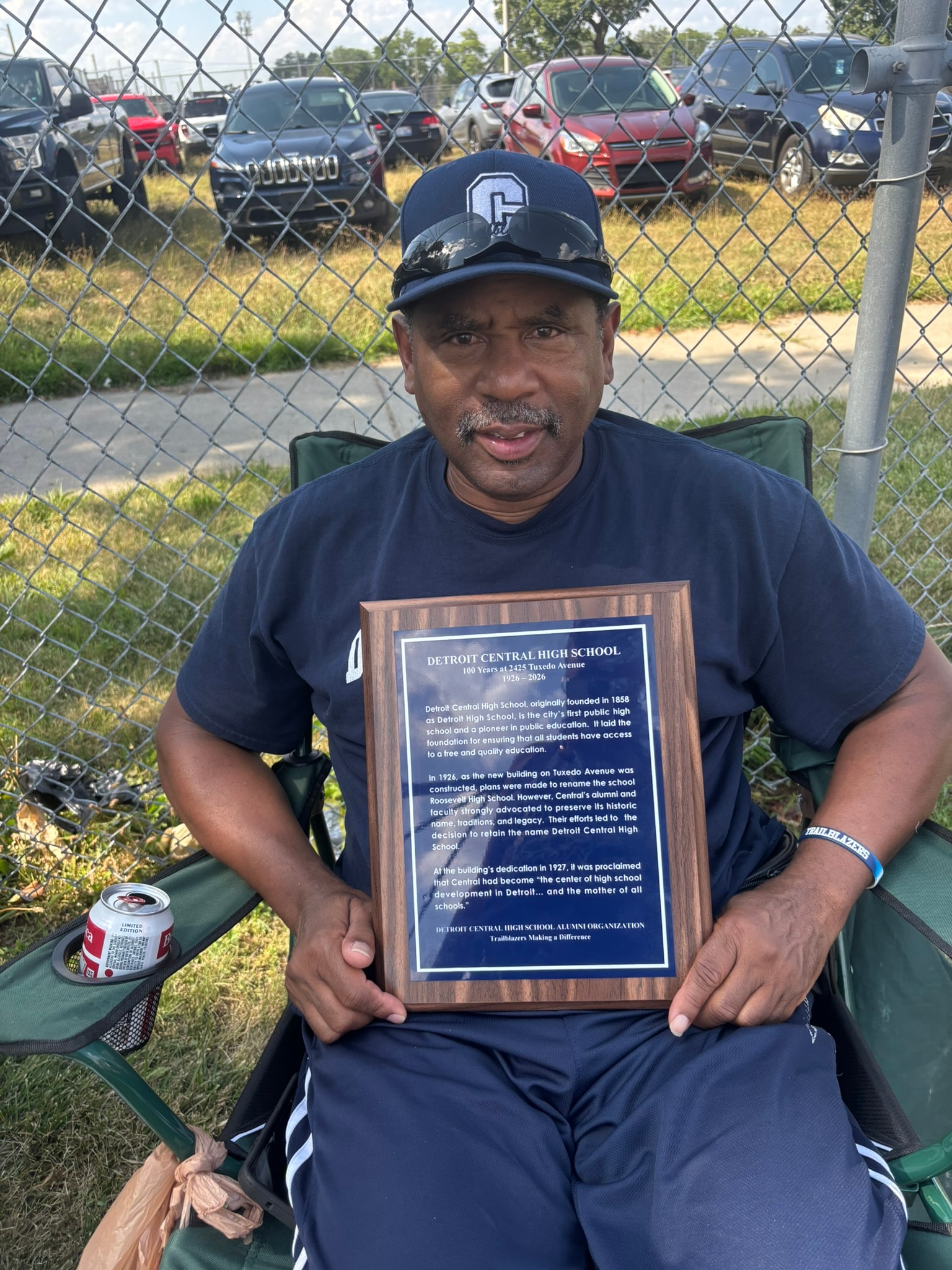 Man holding Detroit Central High School plaque