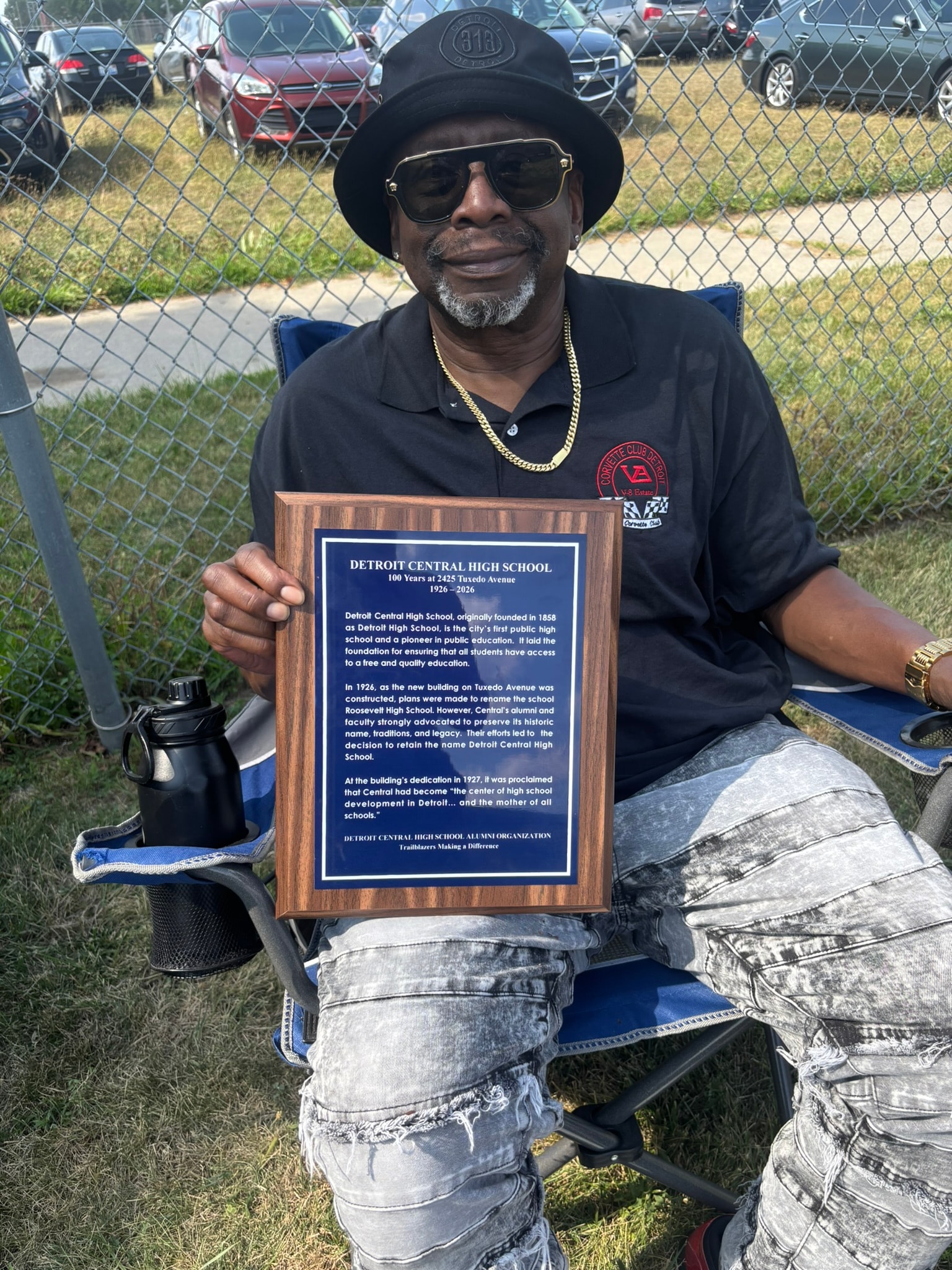 Man holding Detroit Central High School plaque