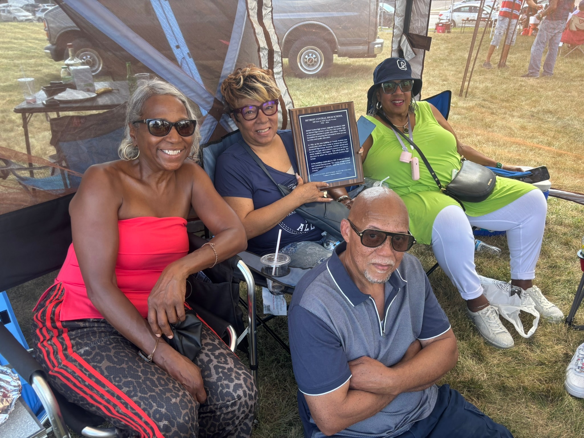 Group celebrating award at outdoor event
