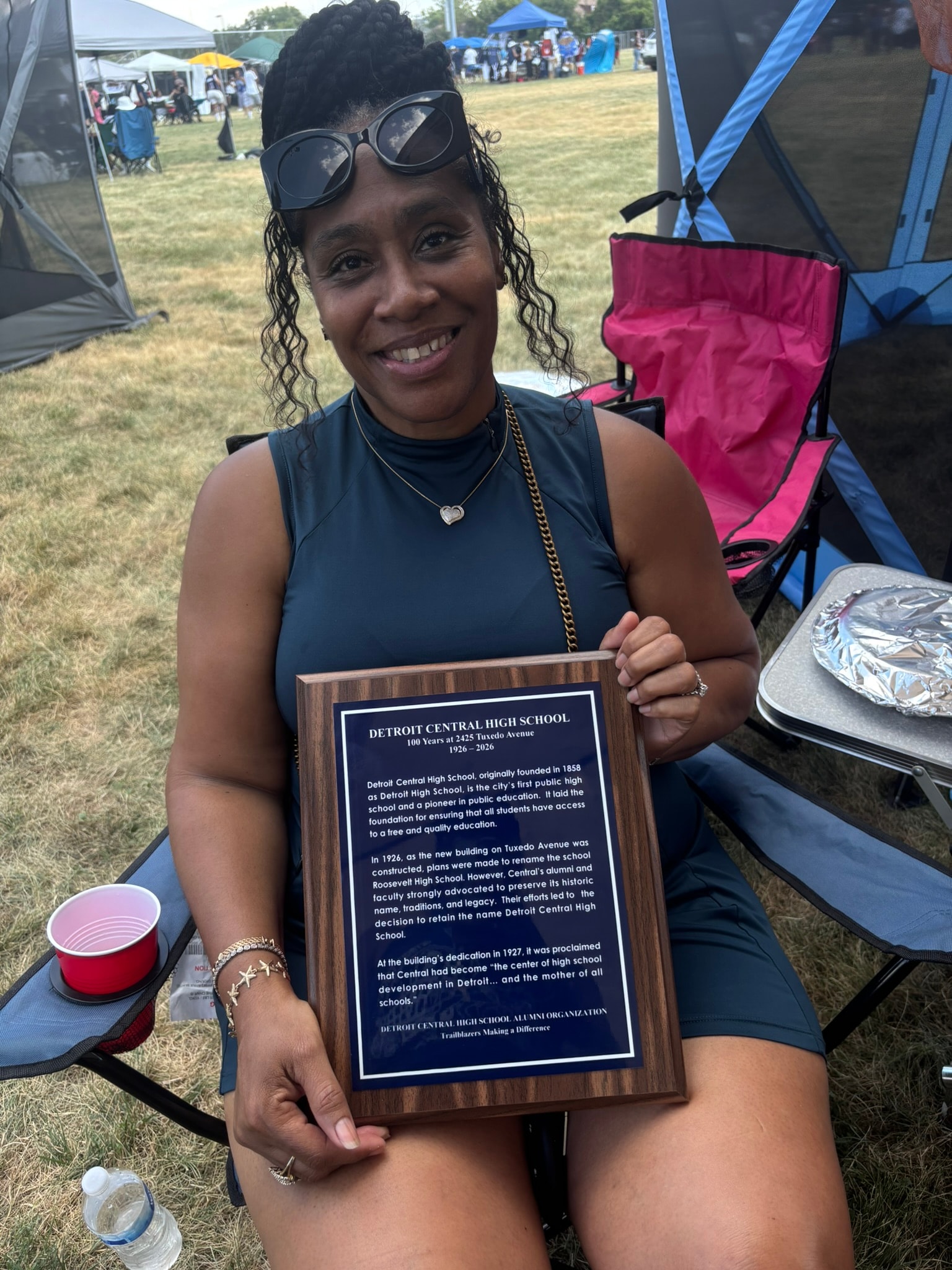 Woman holding Detroit Central High School plaque