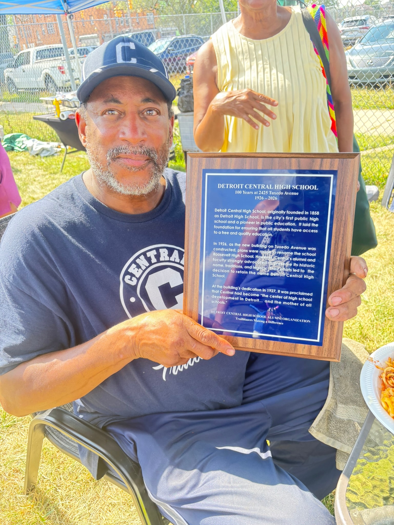 Man holding Detroit Central High School plaque