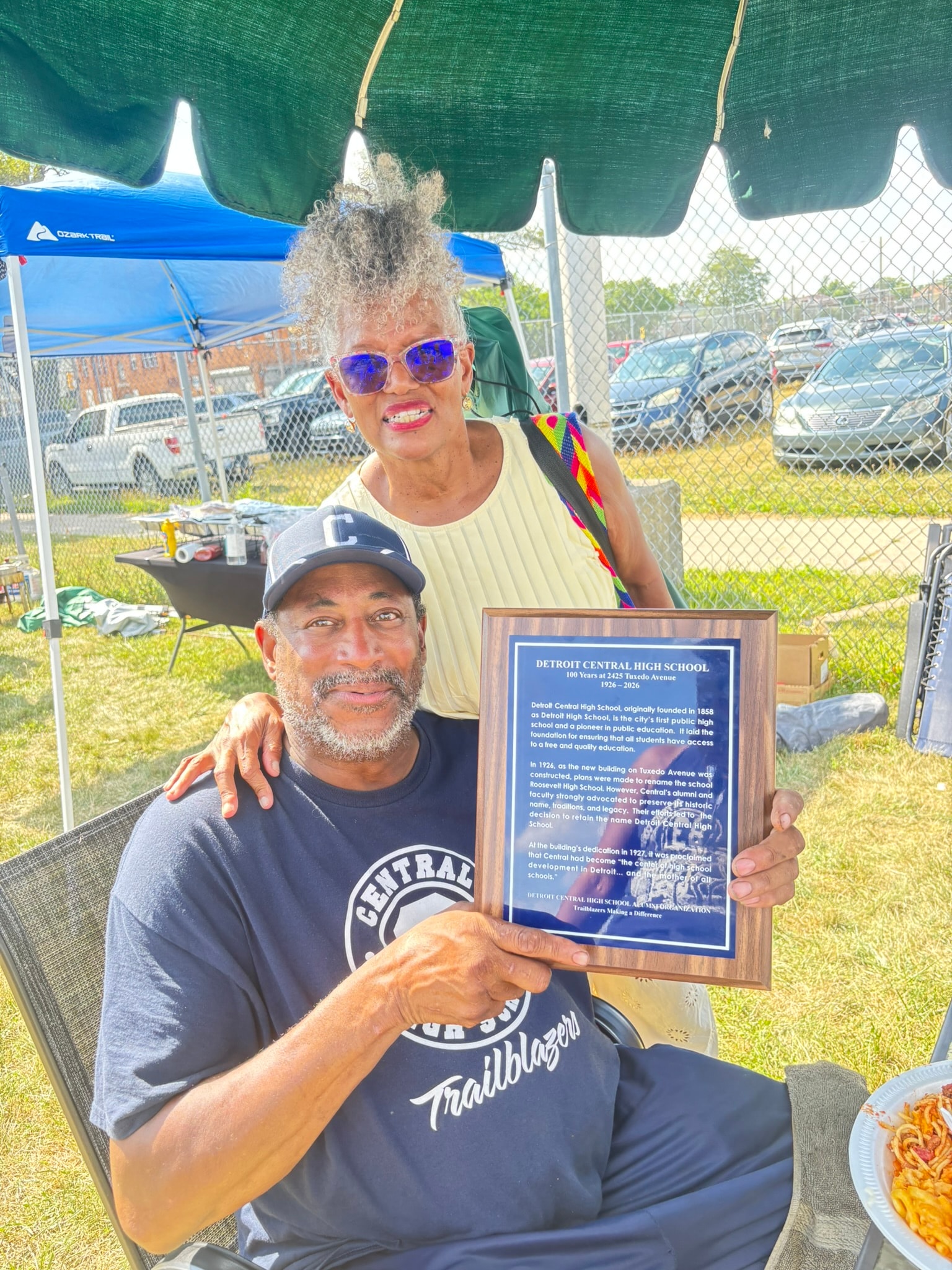 Couple holding Detroit Central High School plaque
