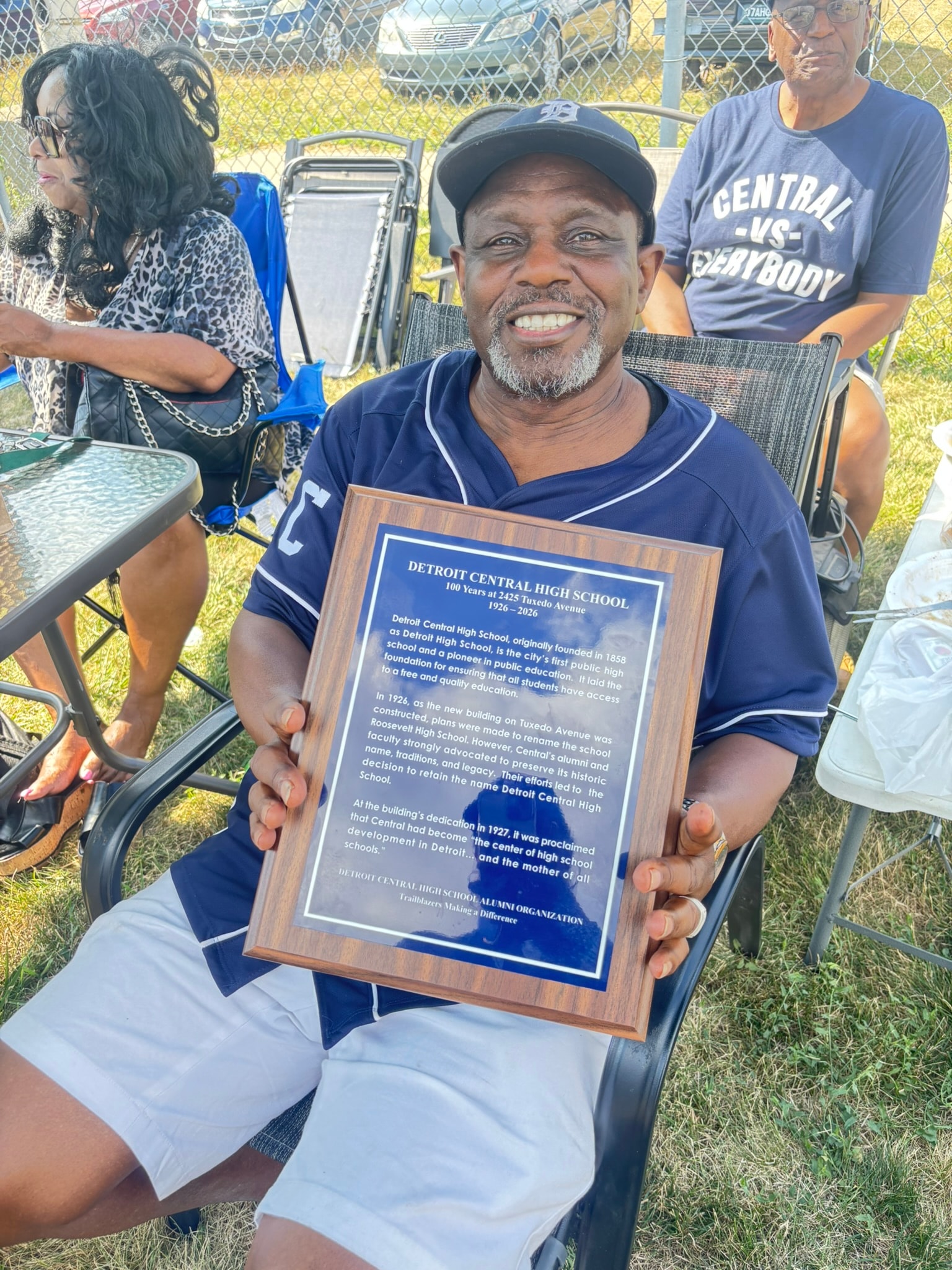 Man holding Detroit Central High School plaque
