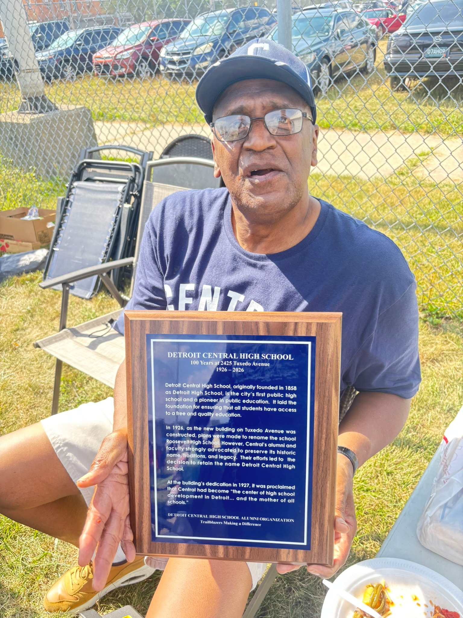 Man holding Detroit Central High School plaque