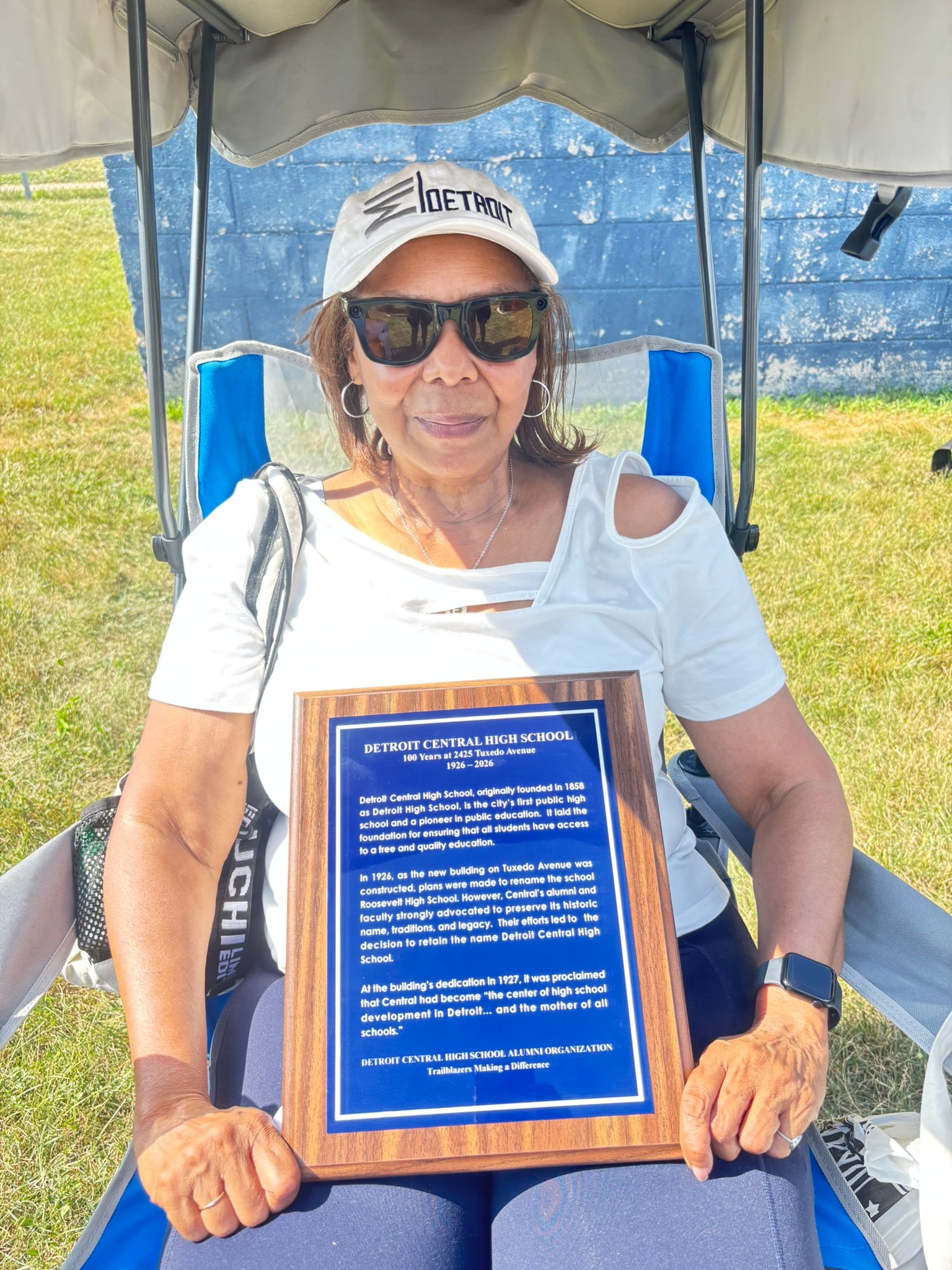 Woman holding Detroit Central High School plaque