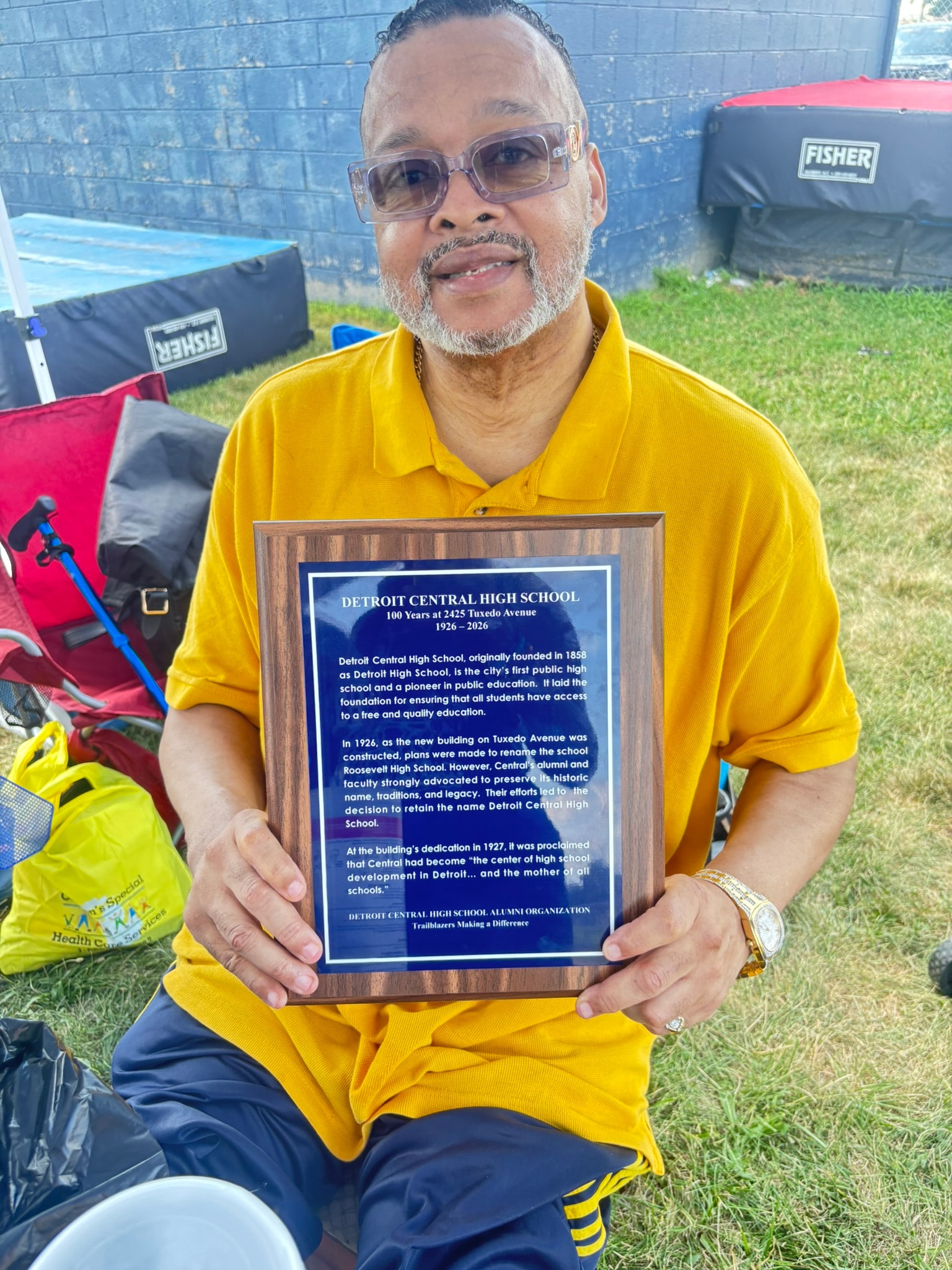 Man holding Detroit Central High School plaque