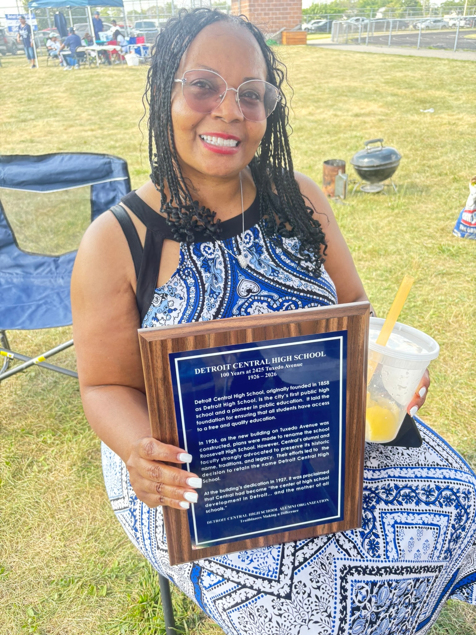Woman holding Detroit Central High School plaque