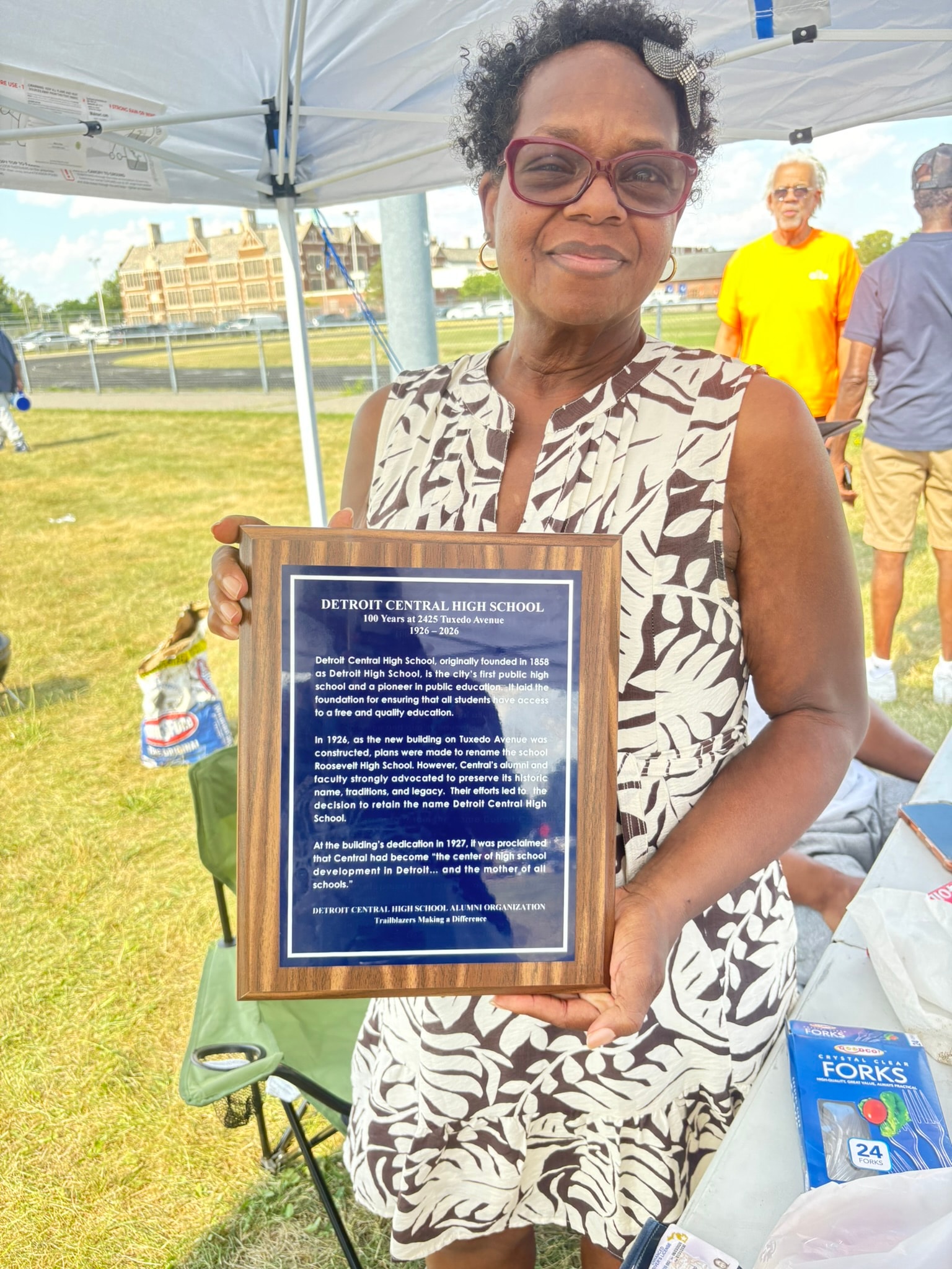 Woman holding Detroit Central High School commemorative plaque