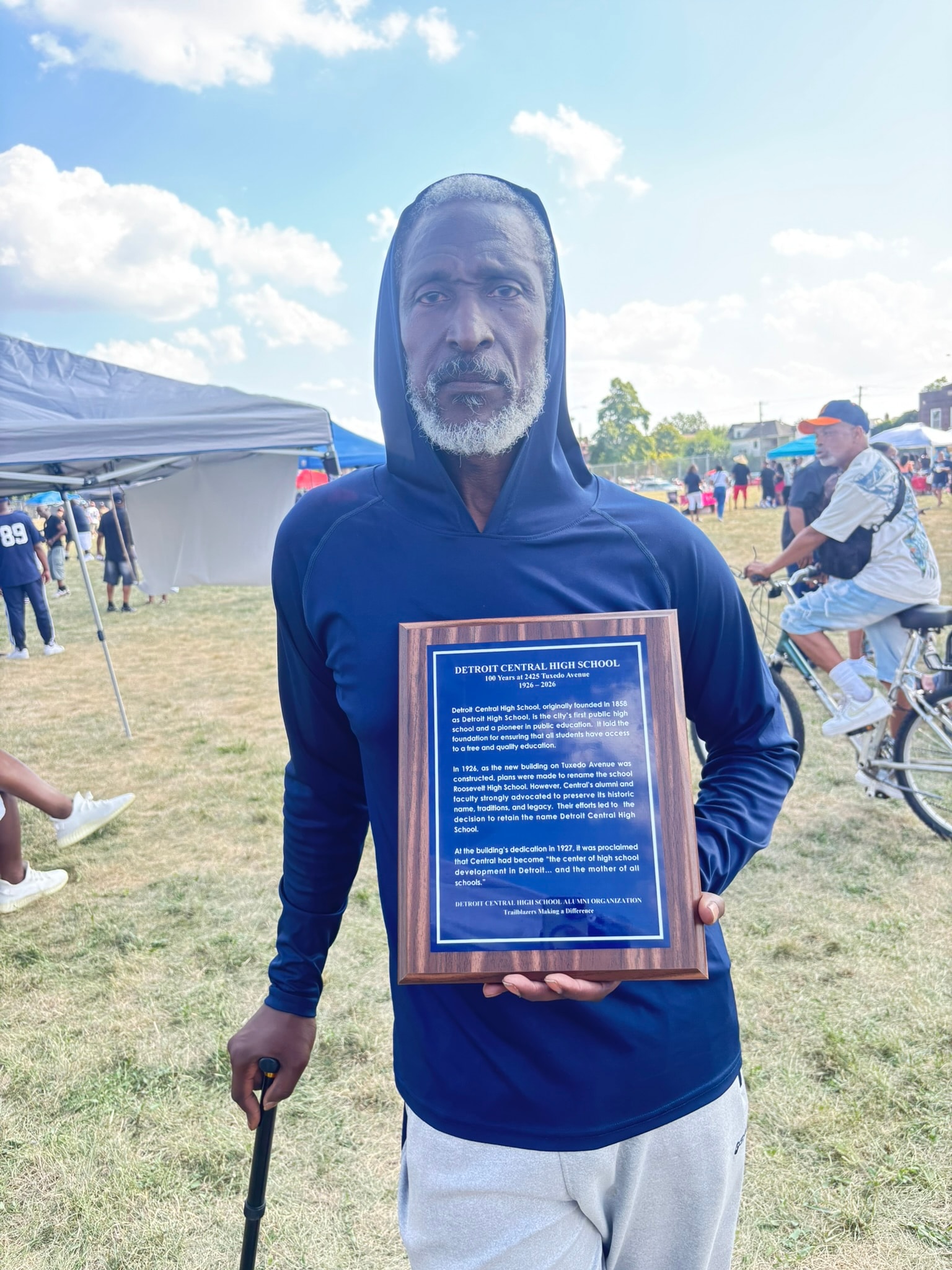 Man holding Detroit Central High School plaque