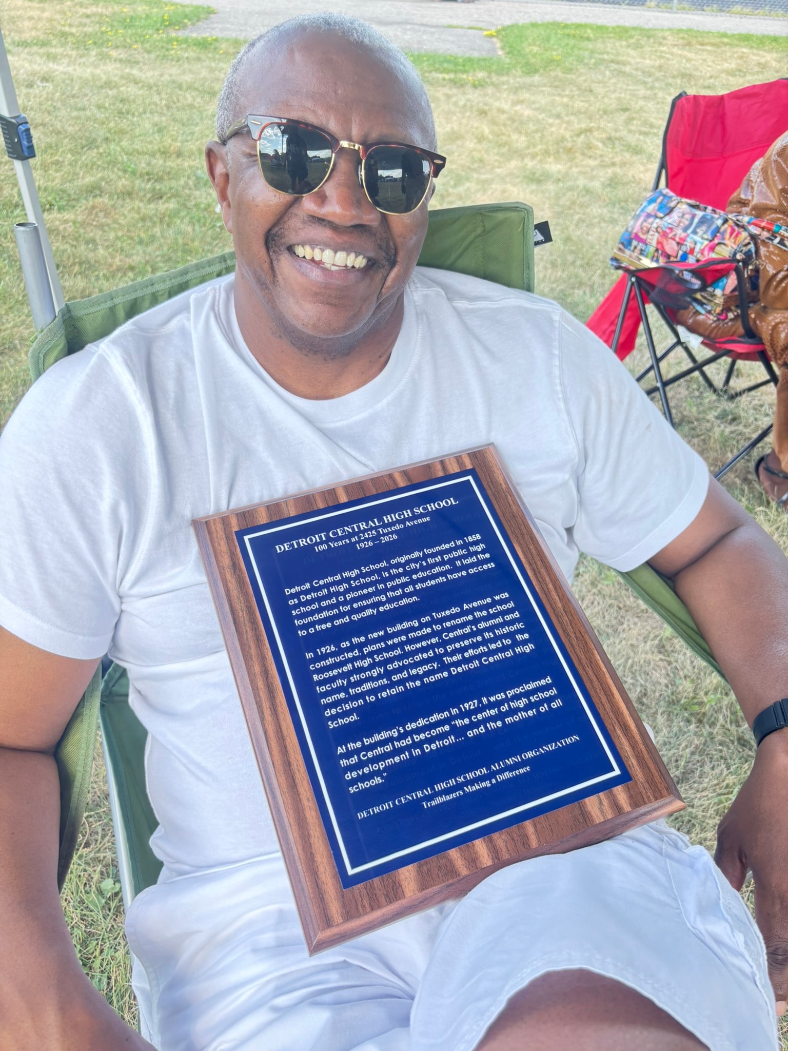 Man holding Detroit Central High School plaque