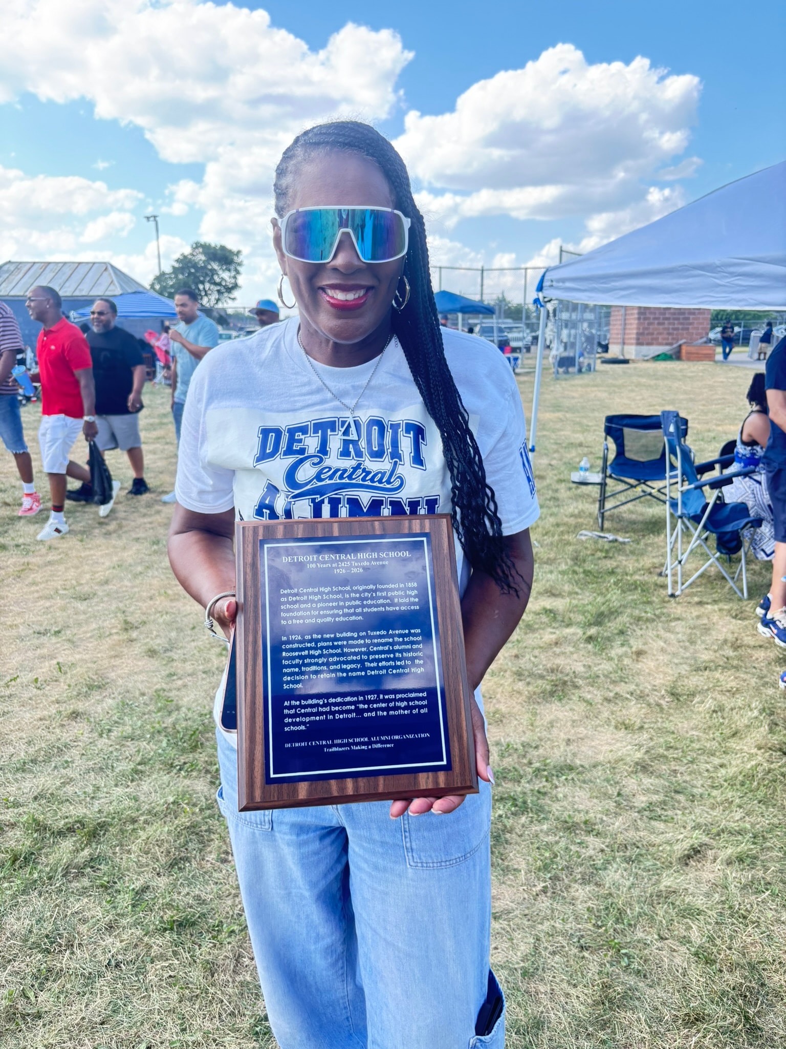 Woman holding Detroit Central High School plaque
