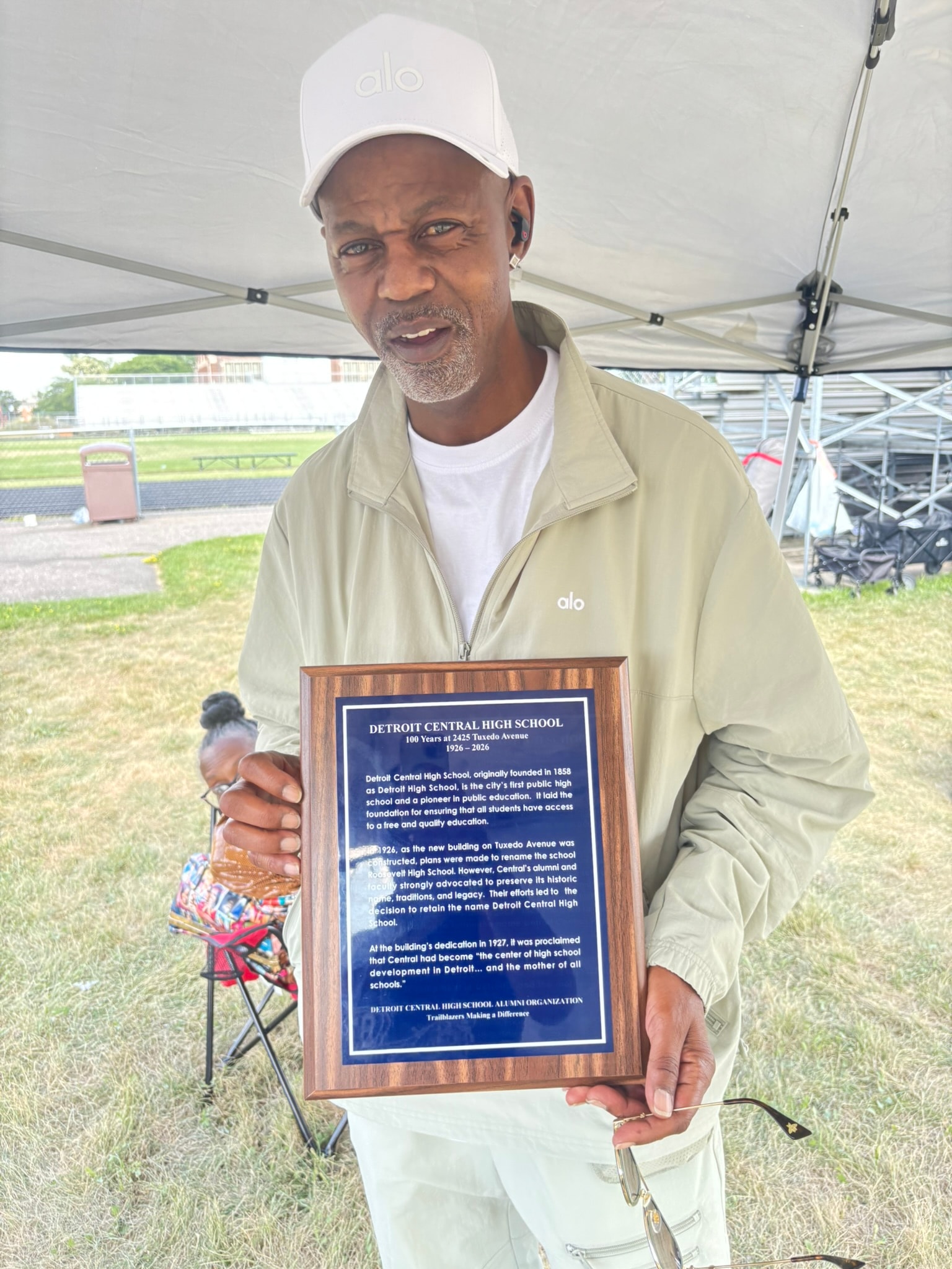 Man holding Detroit Central High School plaque