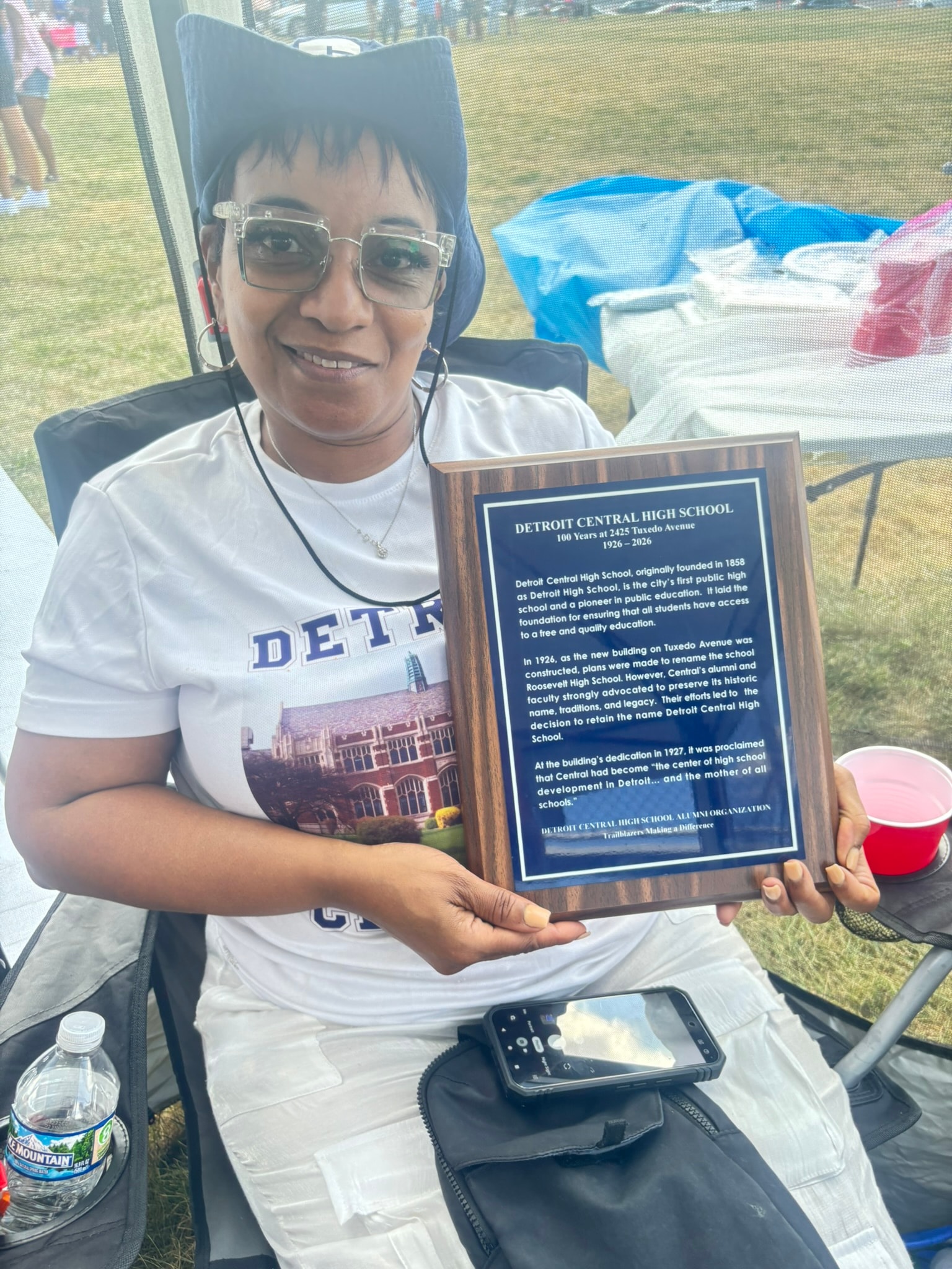 Person holding Detroit Central High School plaque