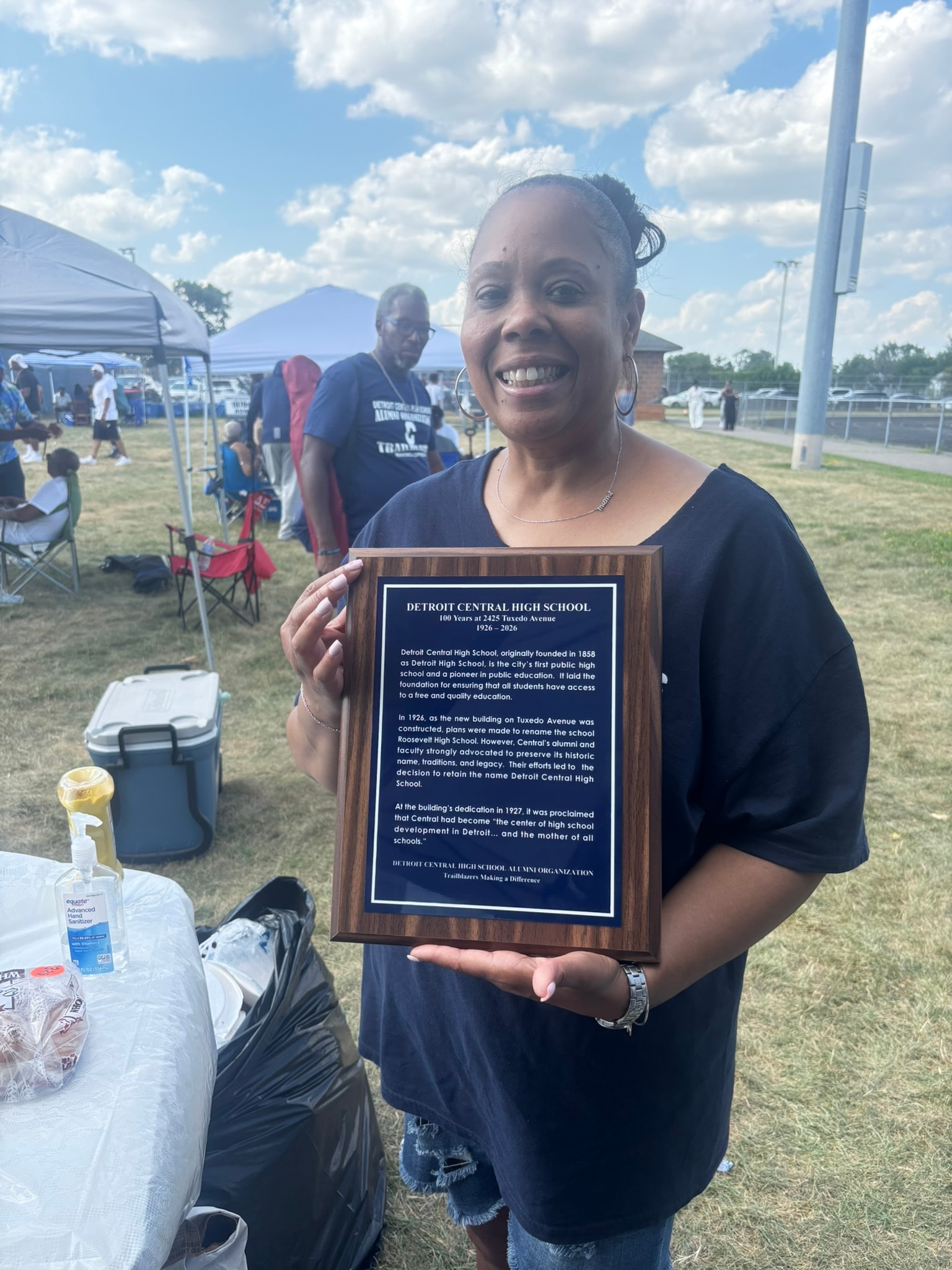 Woman holding Detroit Central High School commemorative plaque