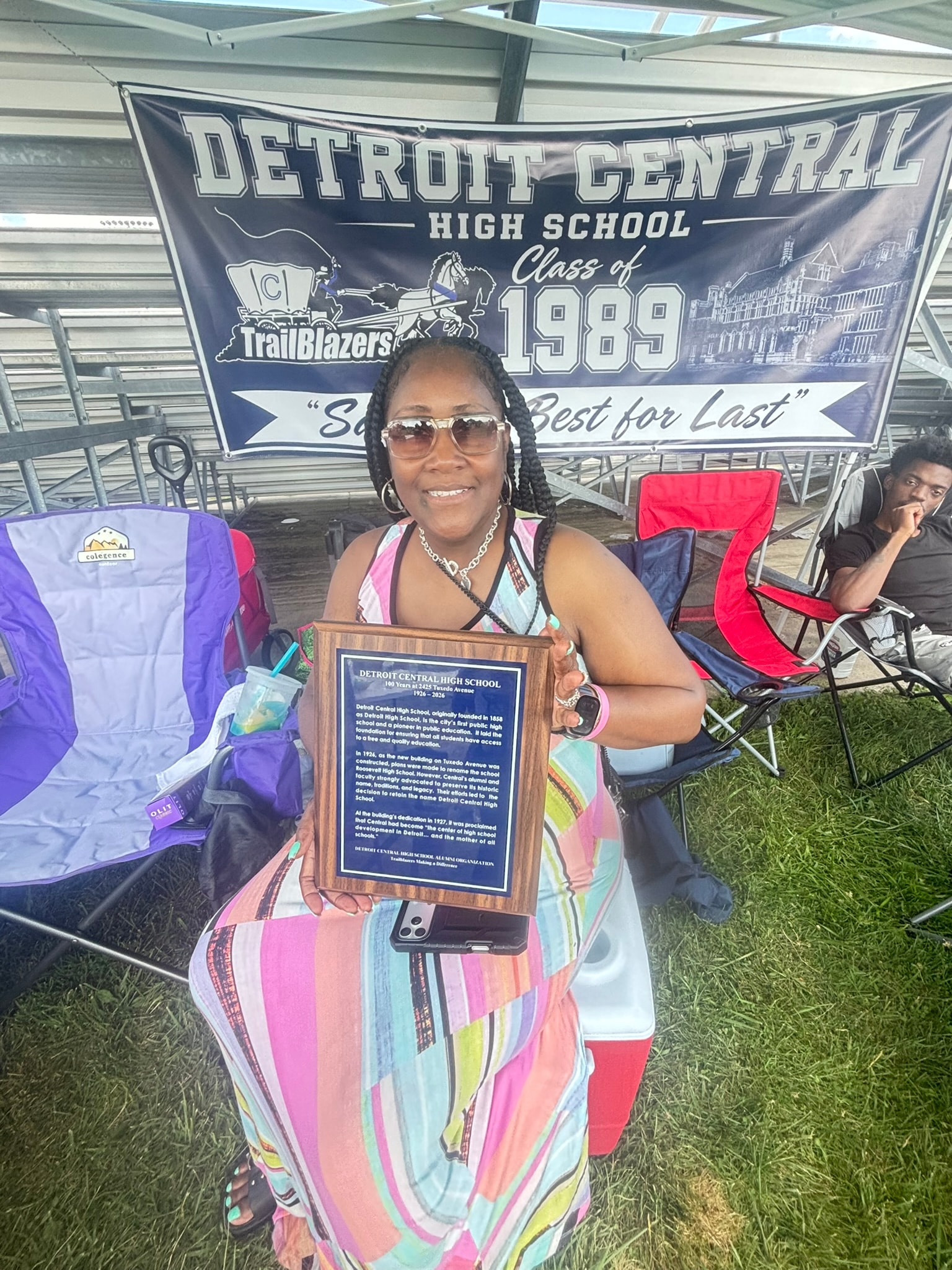 Woman holding plaque Detroit Central High School
