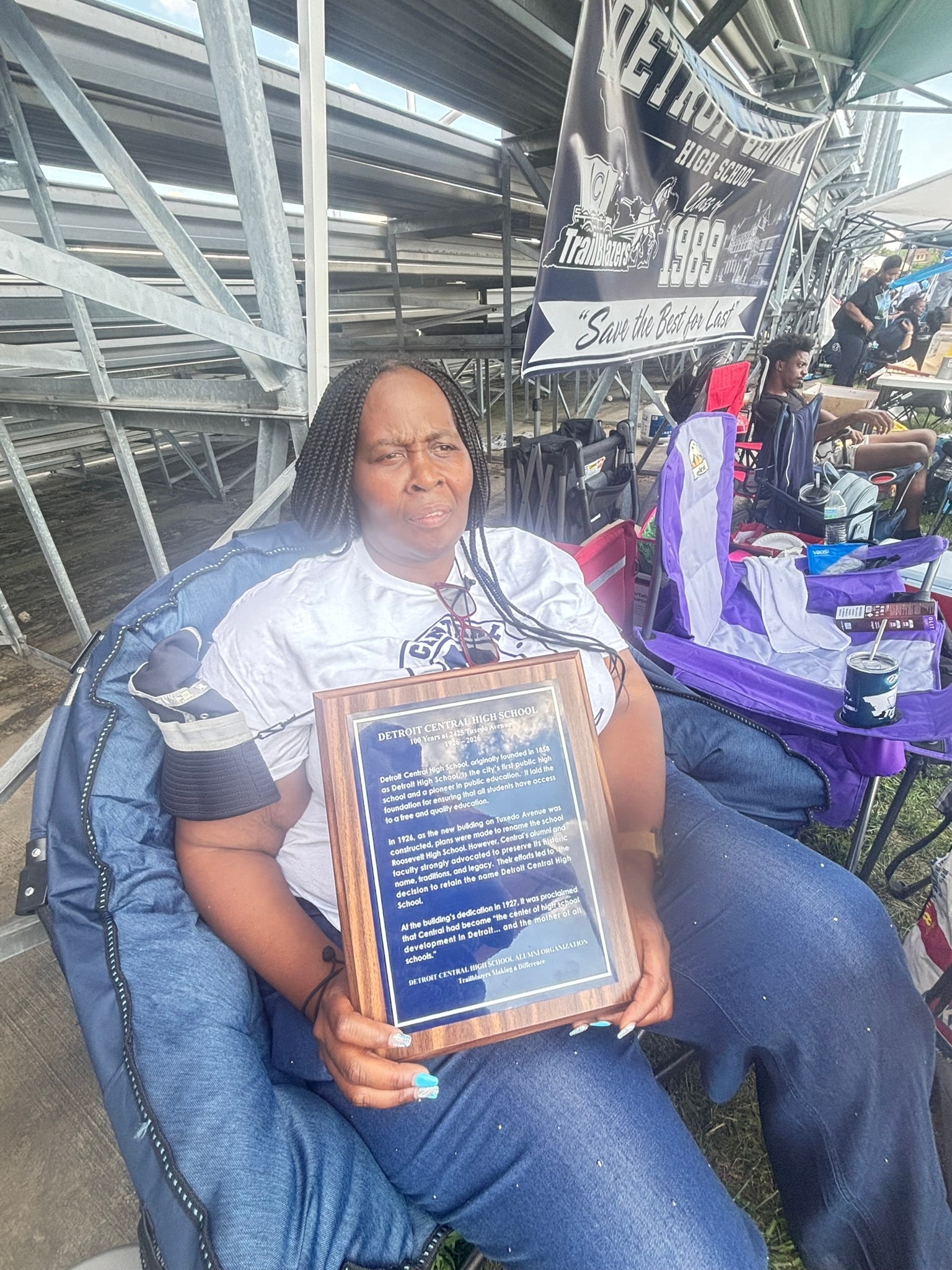 Woman holding Detroit Central High School plaque