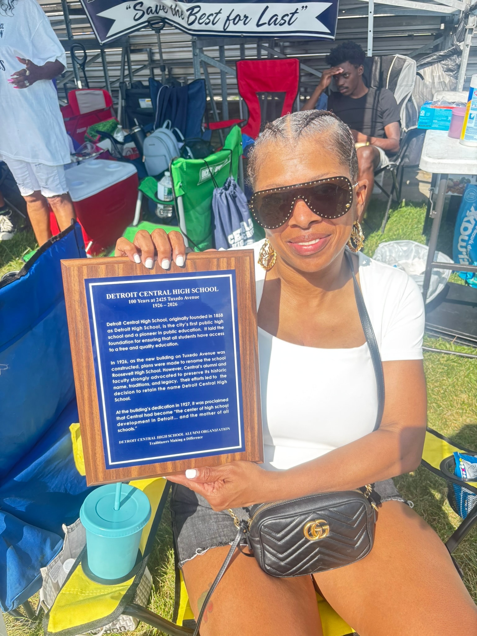 Woman holding Detroit Central High School plaque