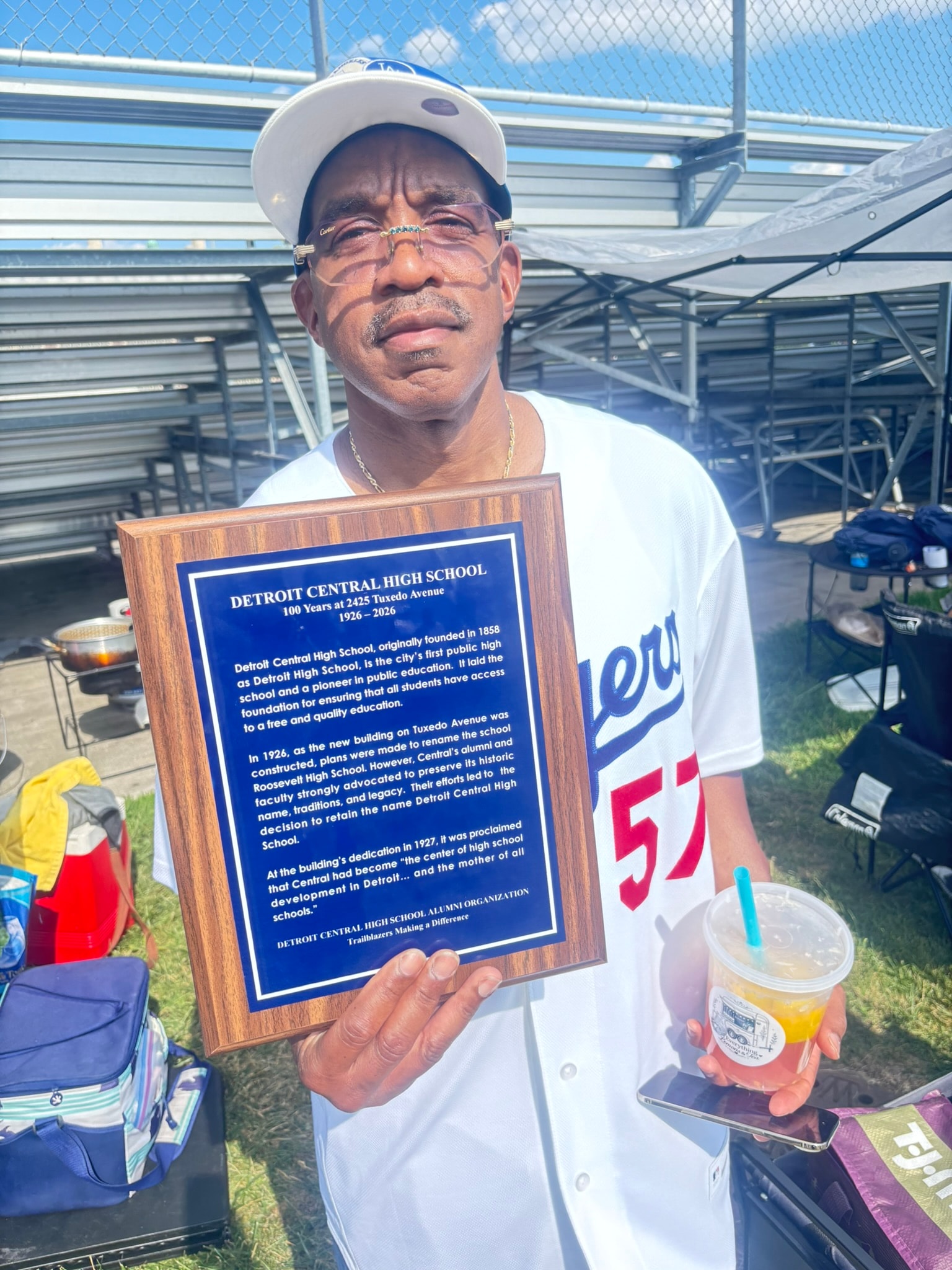 Man holding Detroit Central High School plaque