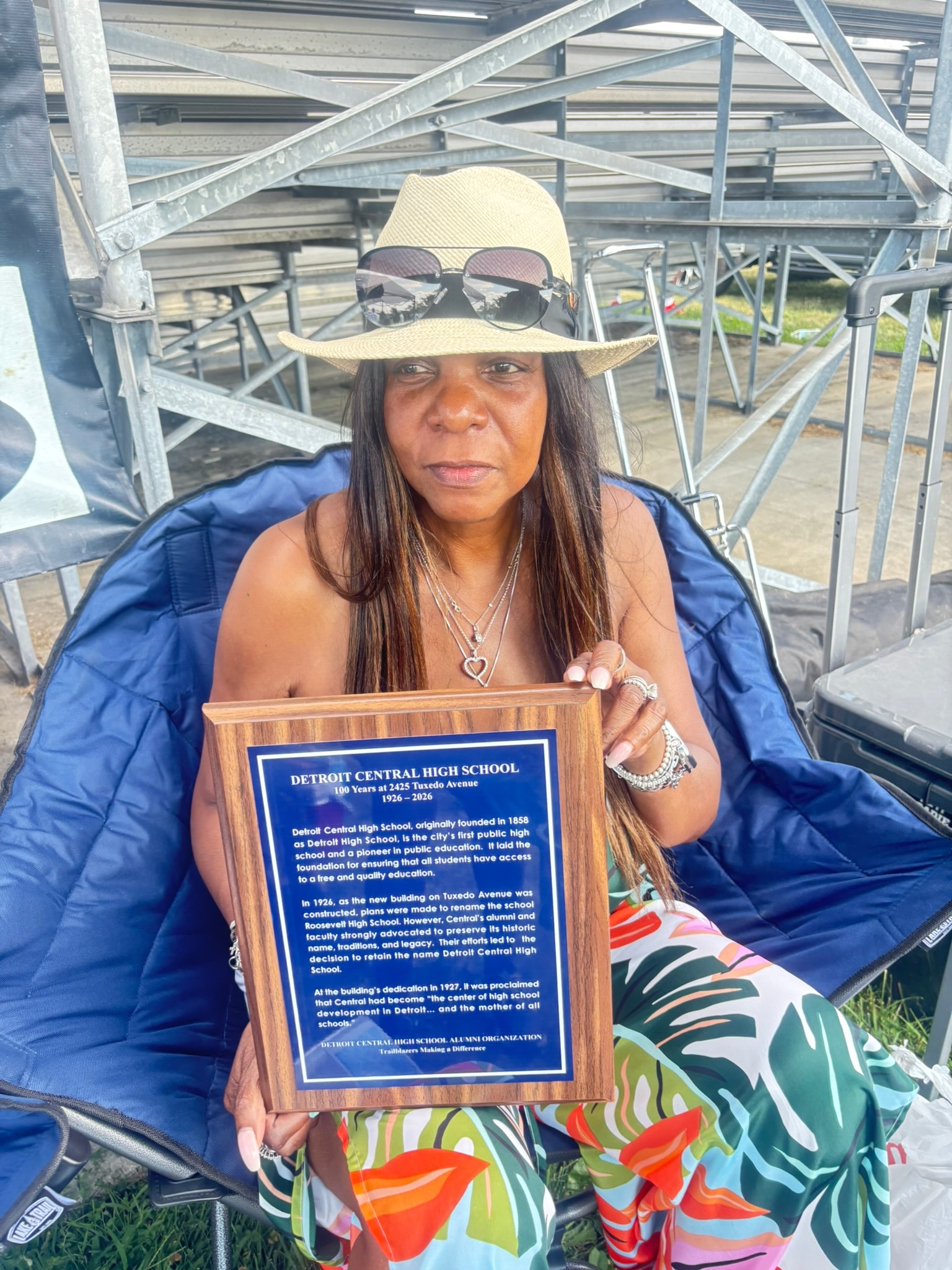 Woman holding Detroit Central High School plaque