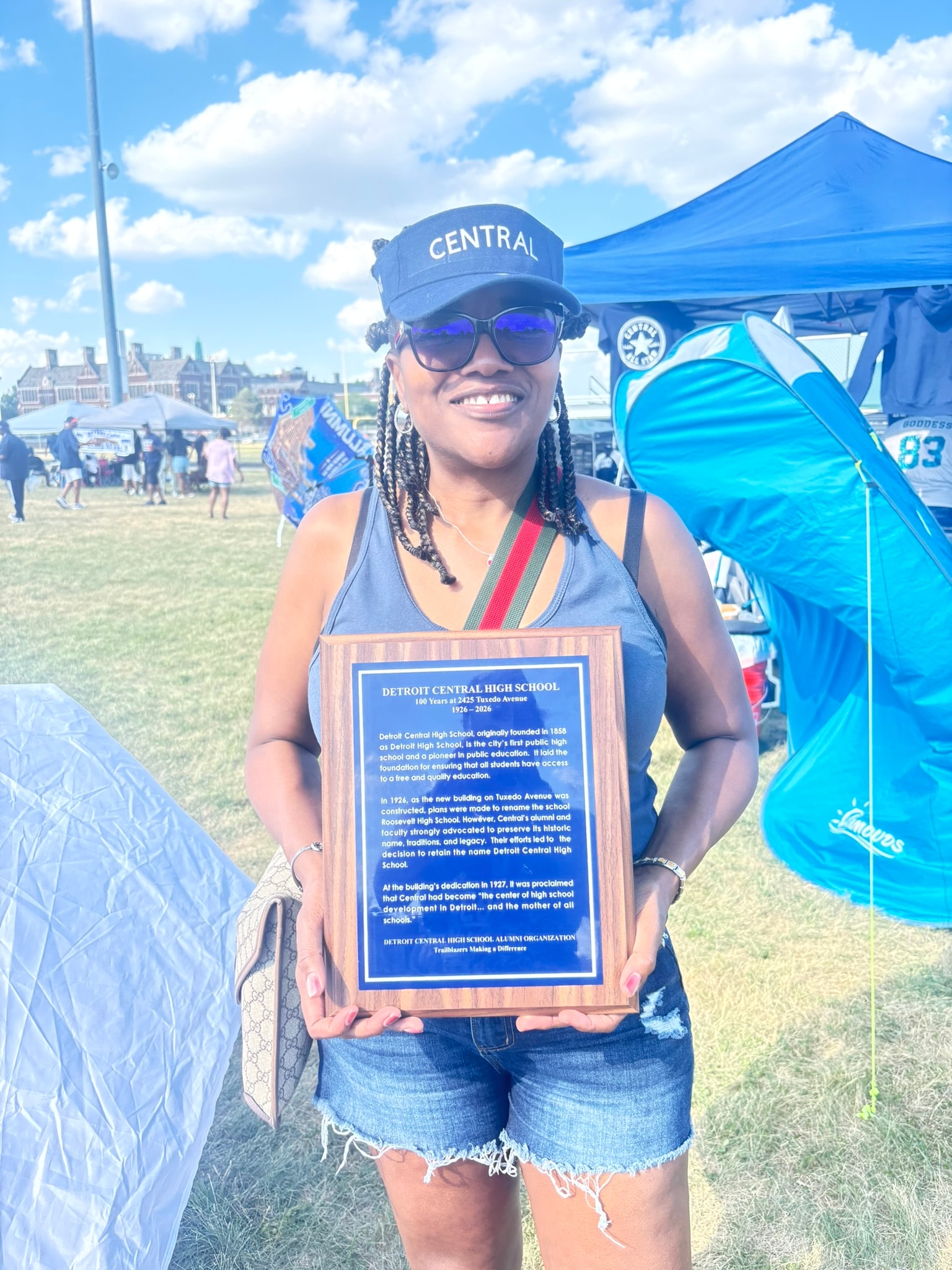 Woman holding Detroit Central High School plaque