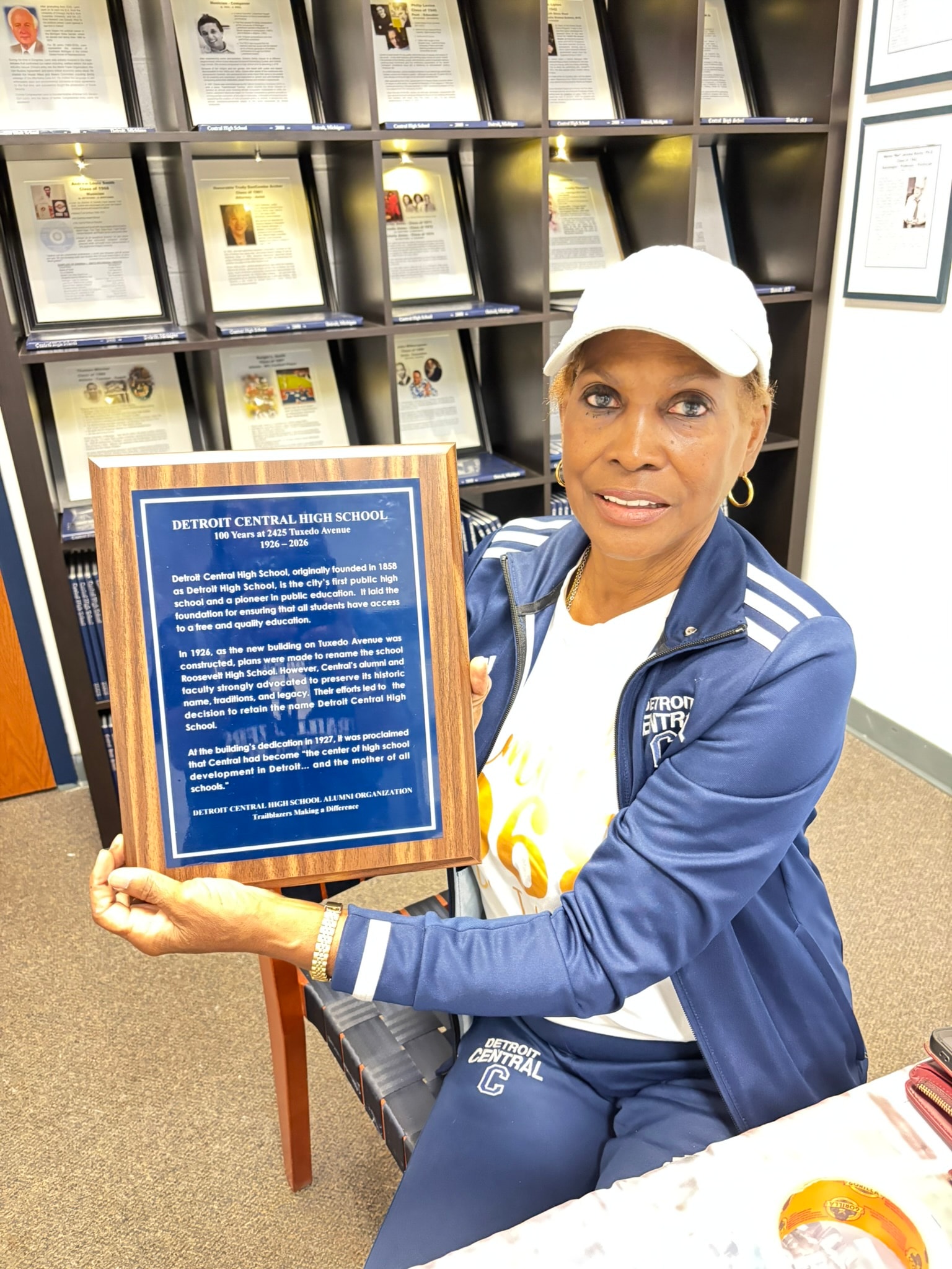 Woman holding Detroit Central High School plaque