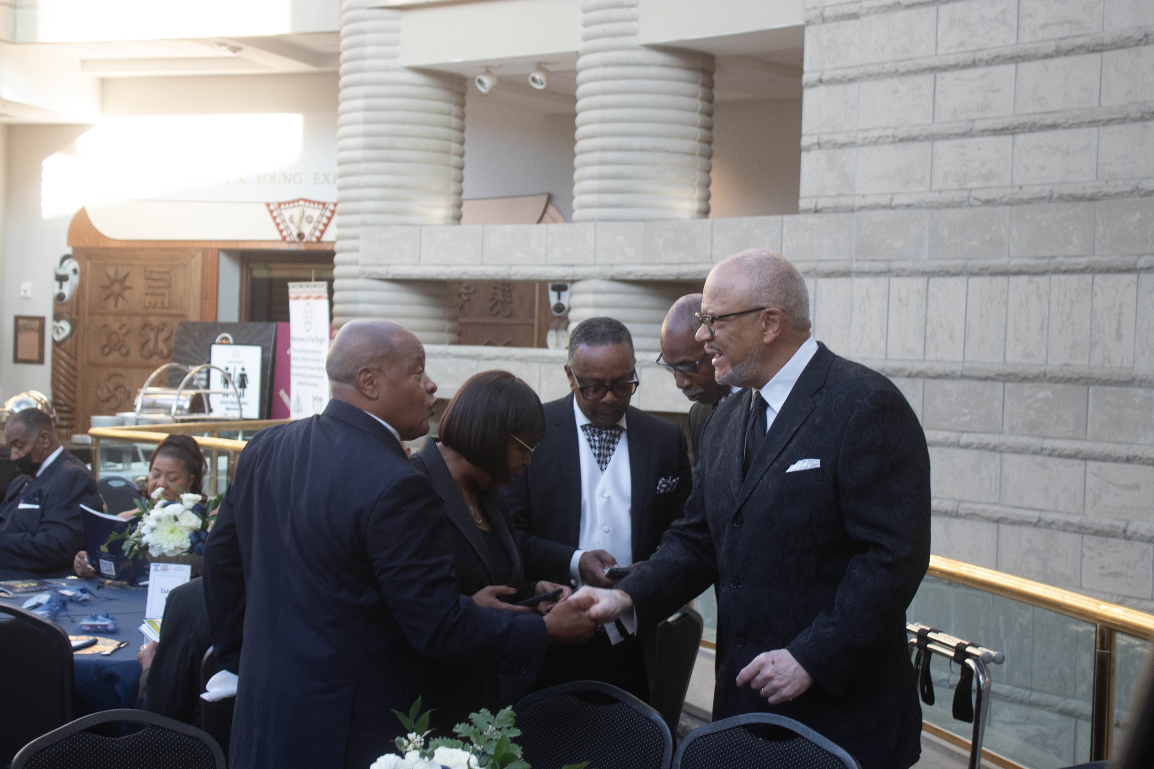 Business professionals networking at formal event