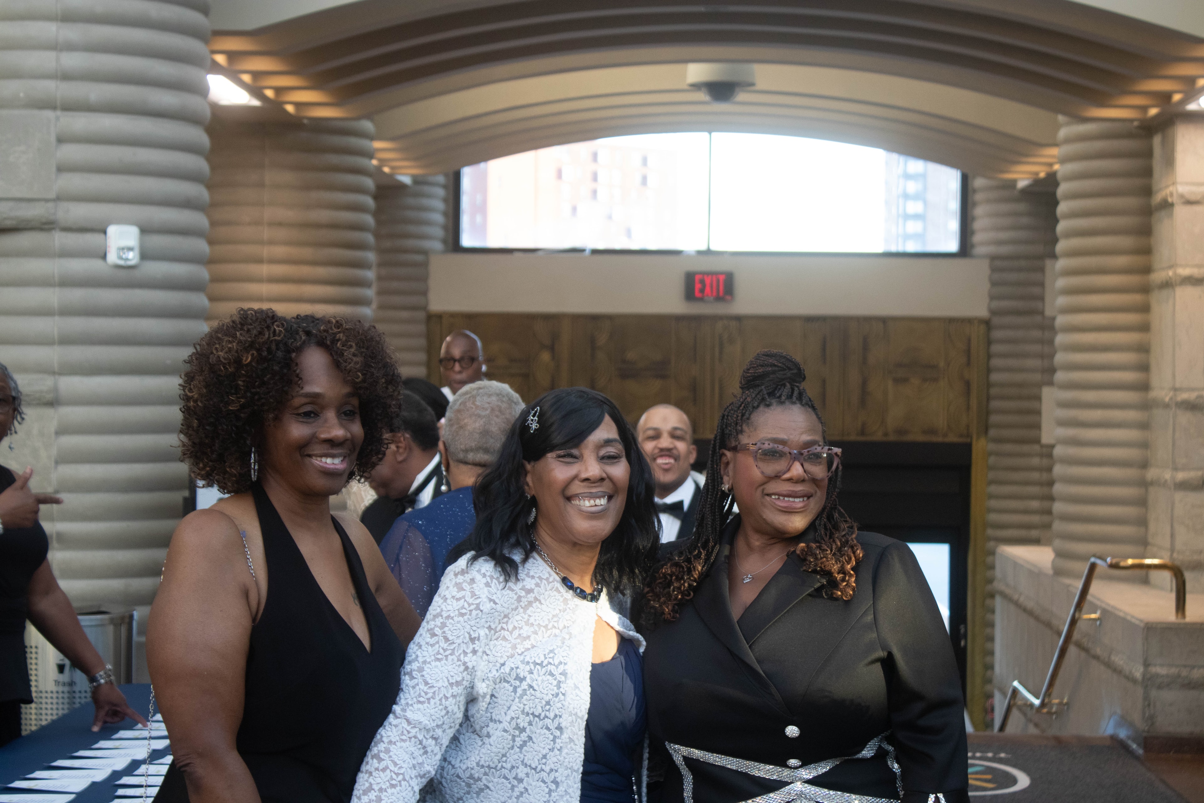 People smiling at formal indoor event