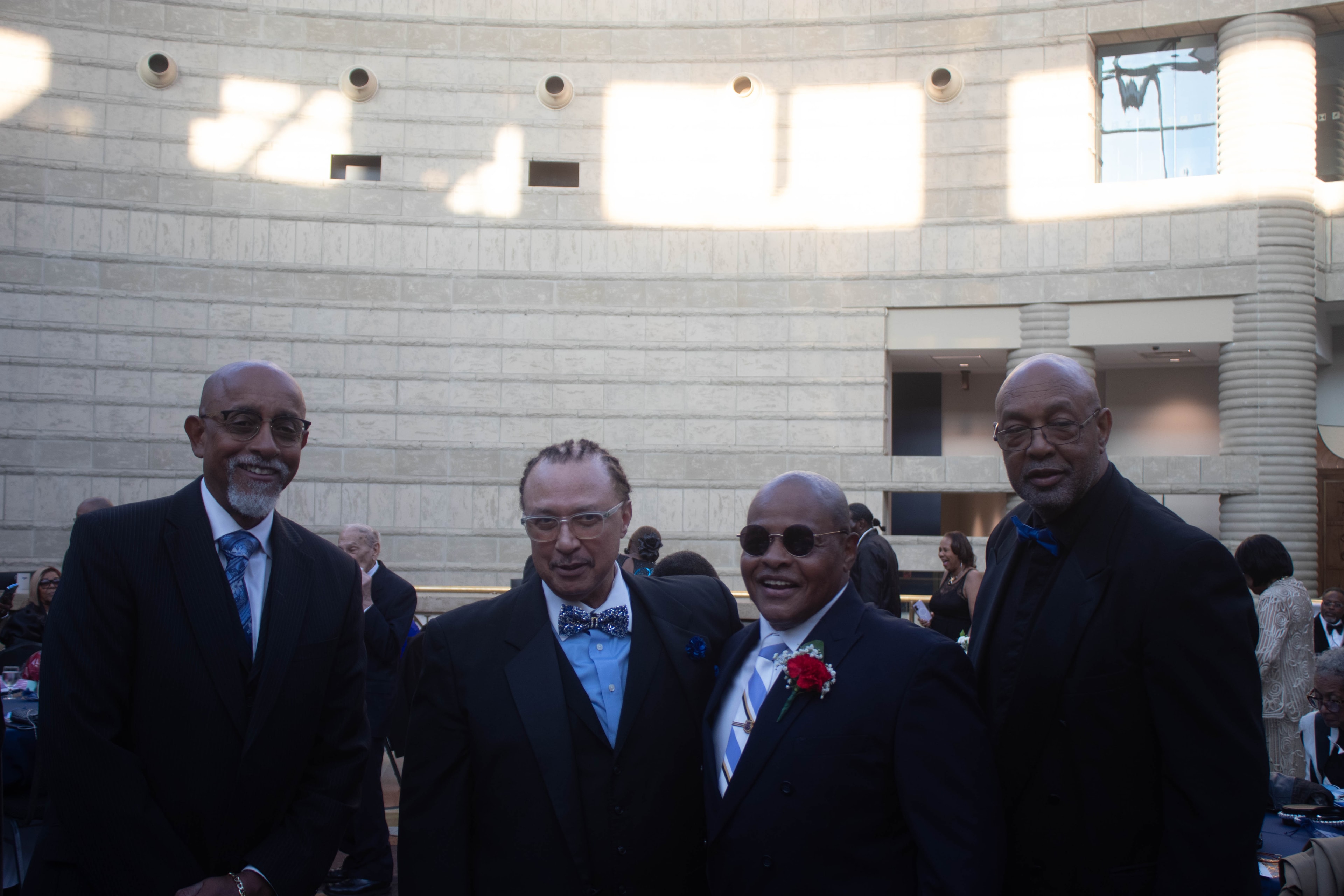 Four men in formal attire at event