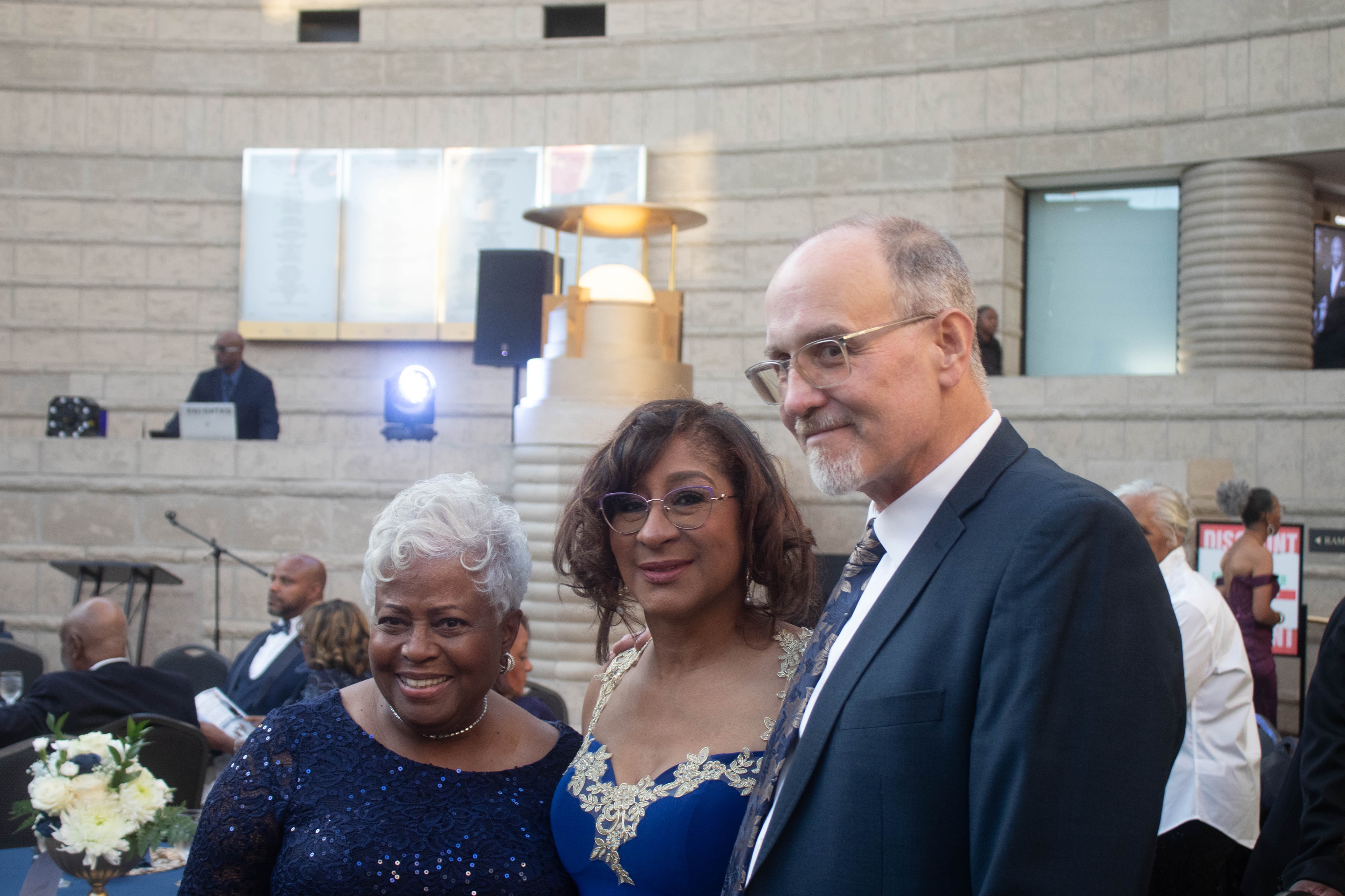 Three people at formal event indoors