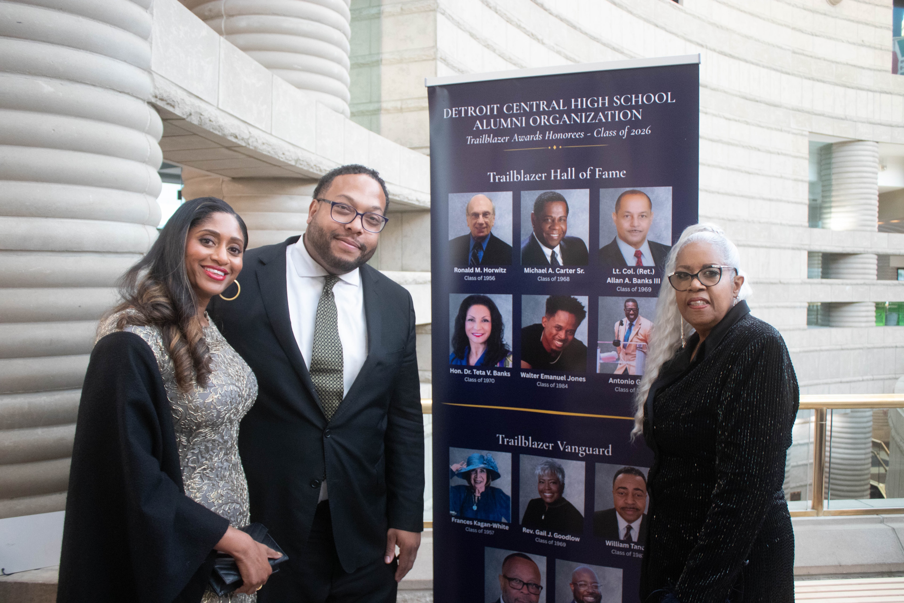 People posing with Detroit Central High School alumni