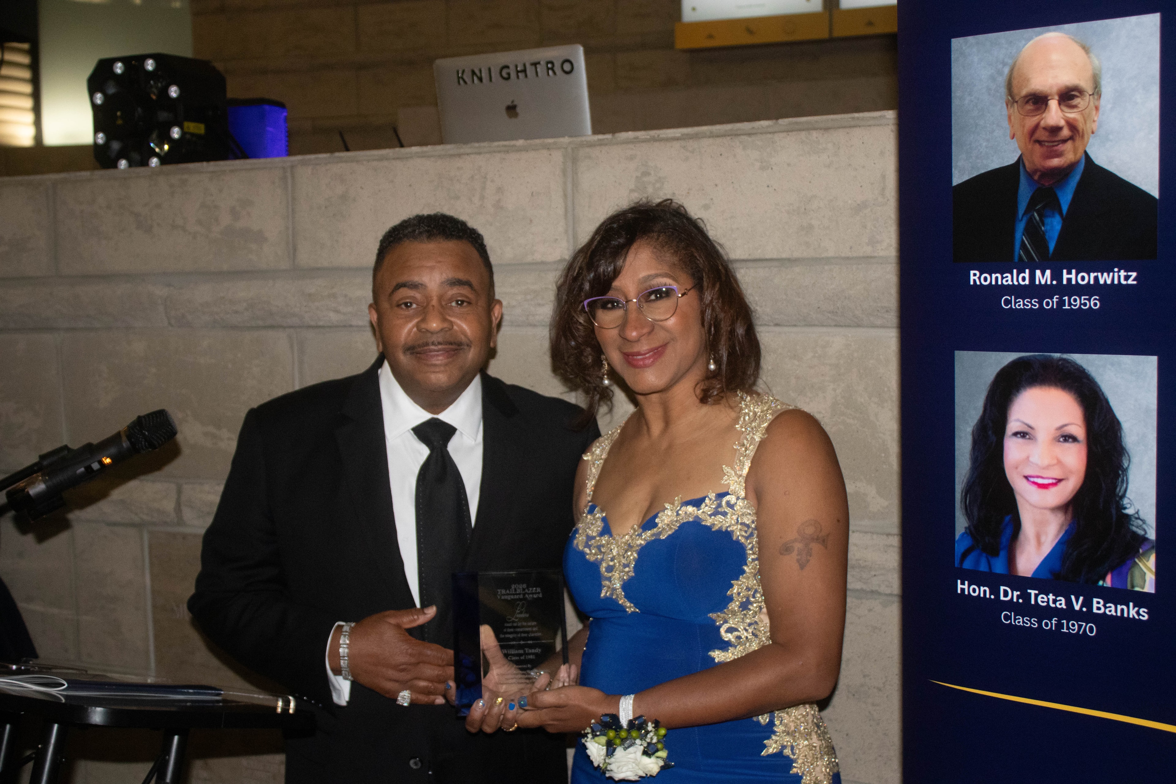 Couple holding award at formal event